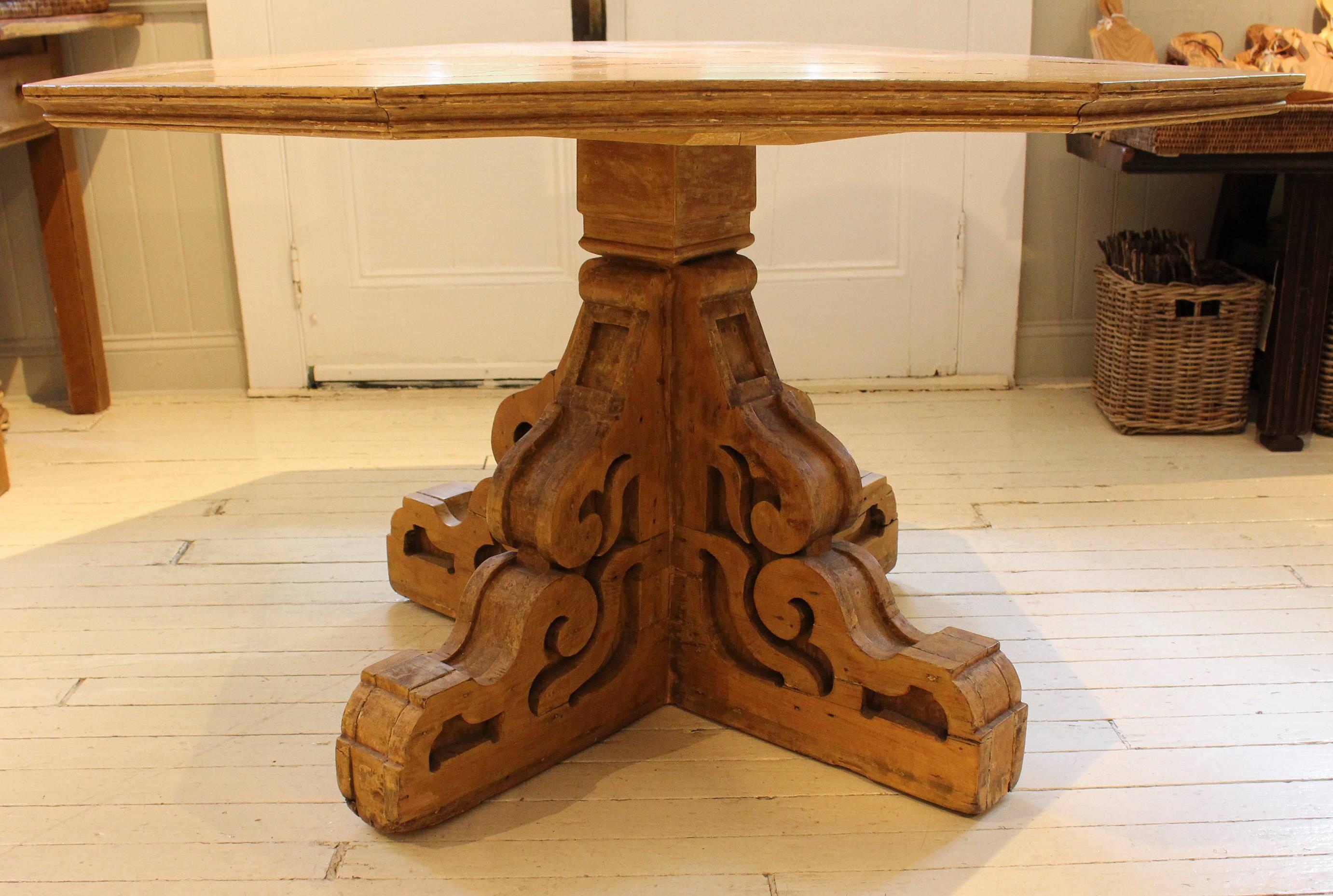 Folk Art table, 19th century USA, with octagonal surface engineered from Mitered boards atop curved bracket base.