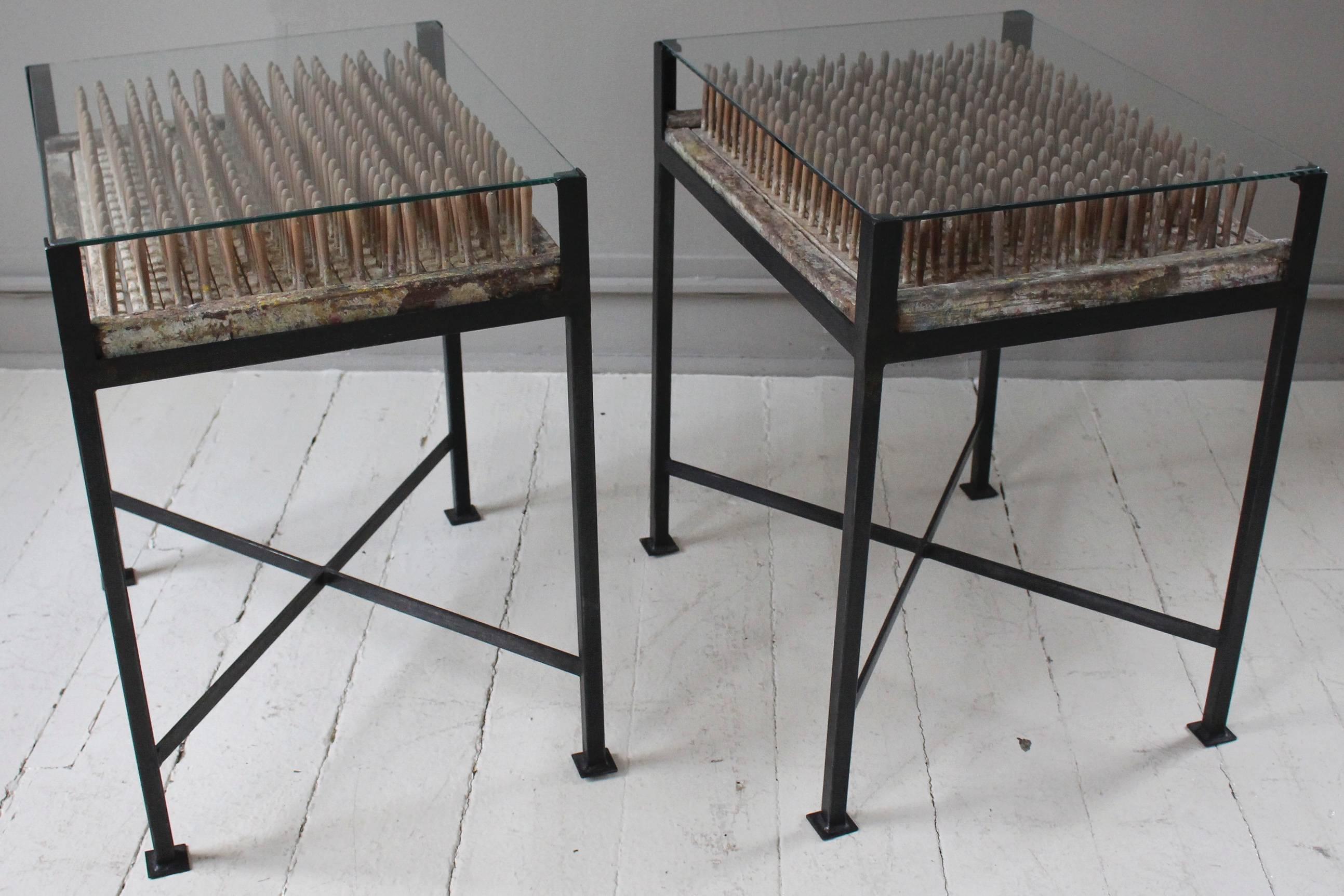 Pair of custom one-of-a-kind side tables fabricated from vintage wood balloon molds set within blackened steel bases with glass tops.