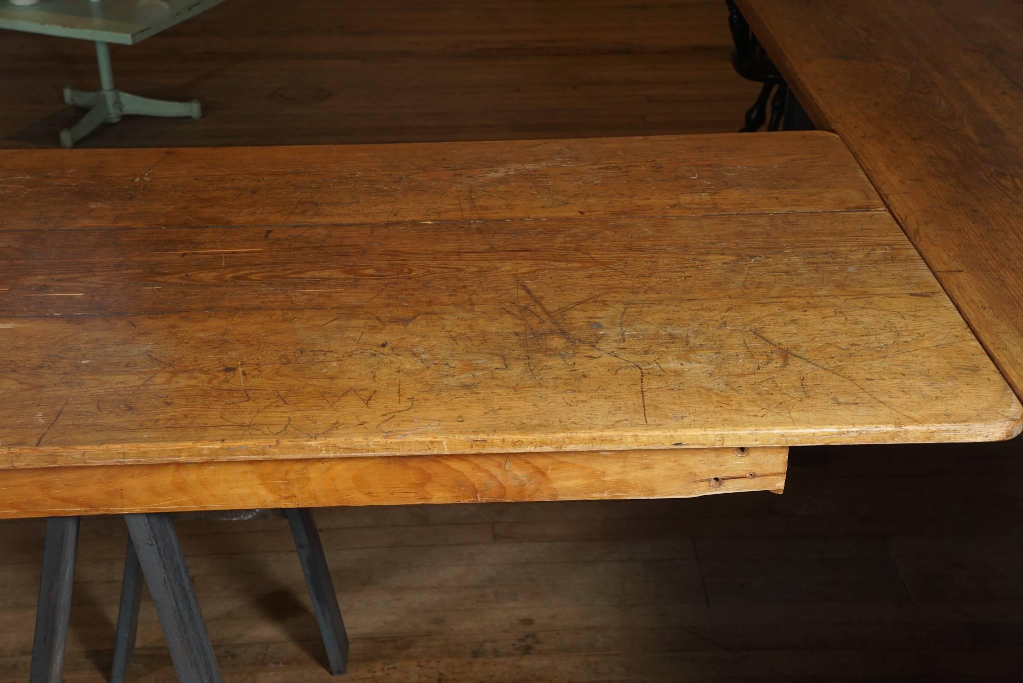 12' dining table, three board fir top - old surface covered in graffiti from a NH church - supported by a pair of stove blackened steel saw horses .