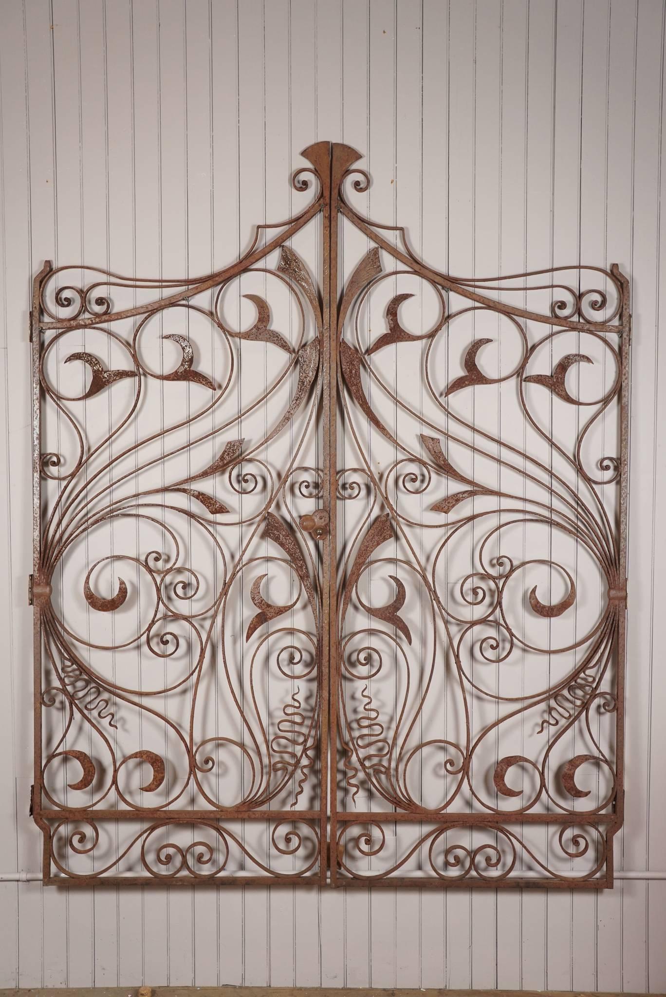 Pair of delicate and intrinsically designed floral motif Art Nouveau wrought iron gates - rusted patina - found in Maine.
