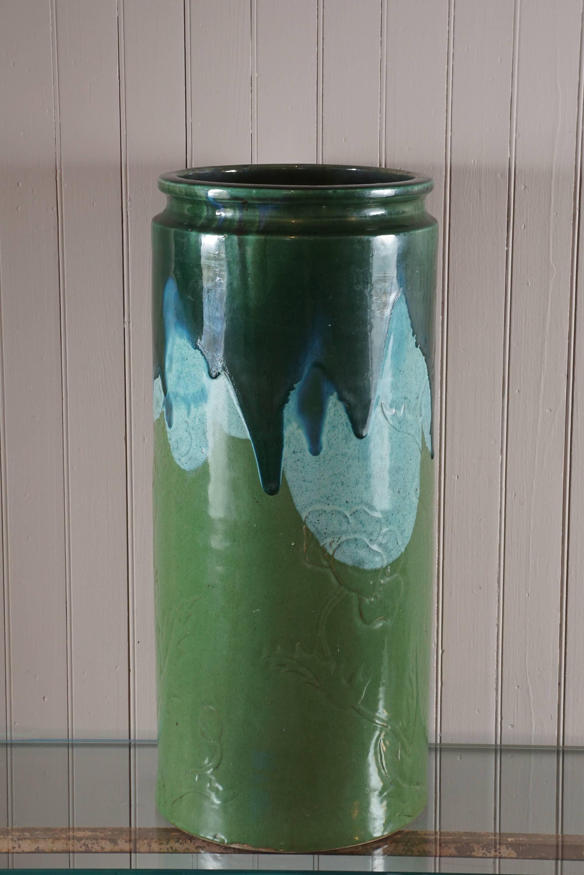 Mid-Century ceramic pot, bas relief of flowers, midnight blue glaze dripping over sky blue and forest green.