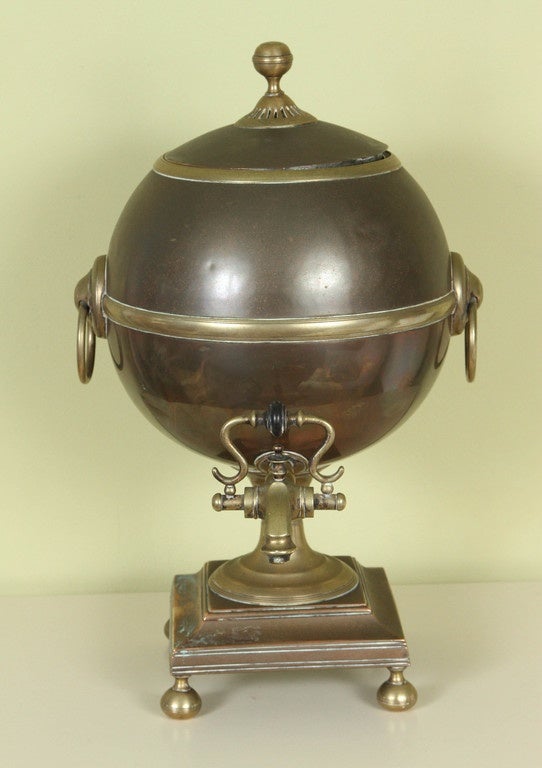 An English copper and brass neoclassical spherical water urn, with a brass spigot, 19th century.