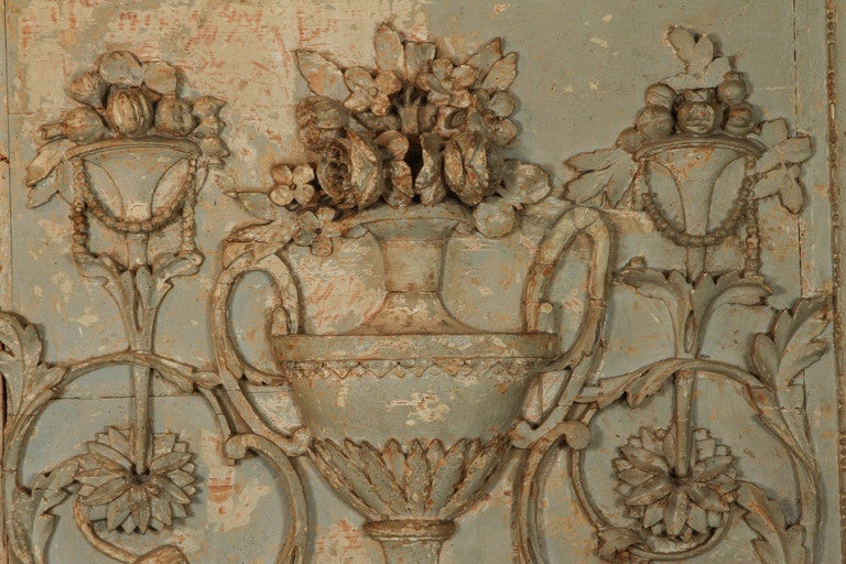 An 18th century Louis XVI carved and painted panel featuring Classic elements of an urn with floral decoration on an acanthus leaf base with 