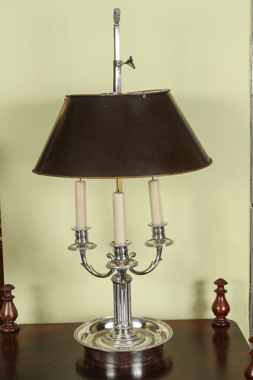 A silvered brass Bouillotte lamp with a tole shade, late 19th century