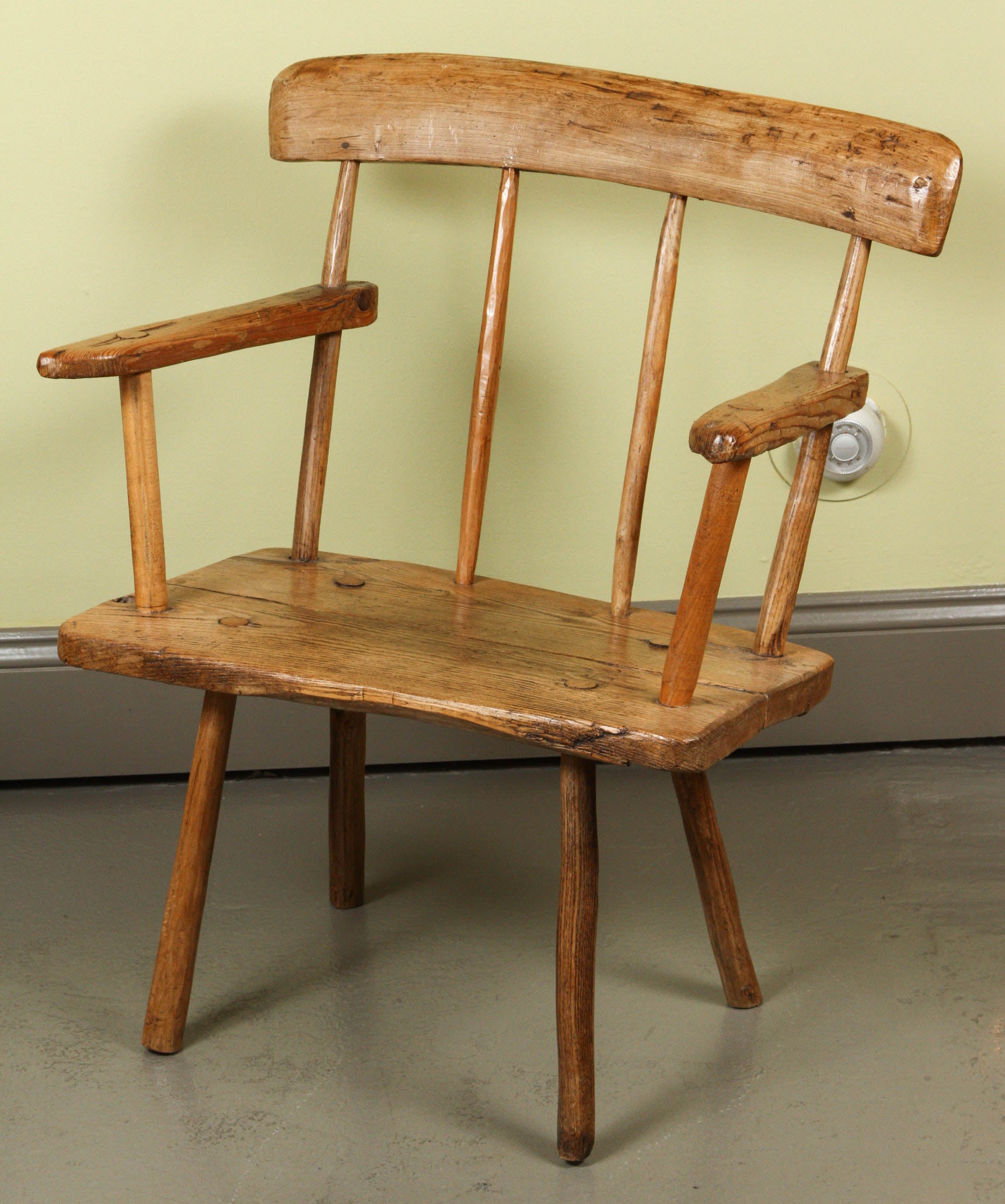 An Irish Pine and Oak "Hearthside" Chair, circa 1840
