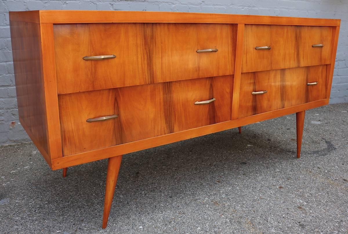 Brazilian 1960s sideboard in caviuna wood with brass details and four drawers.  Can also be used as a dresser
