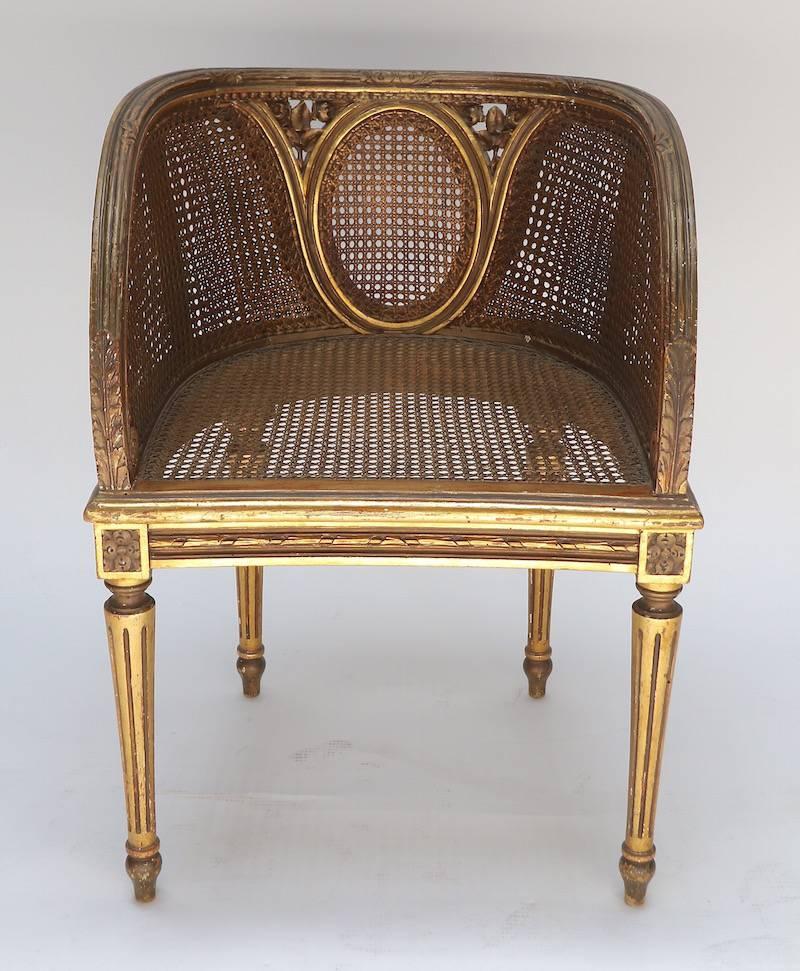 Louis XVI style chair from the 1920s with gilding and cane seat.