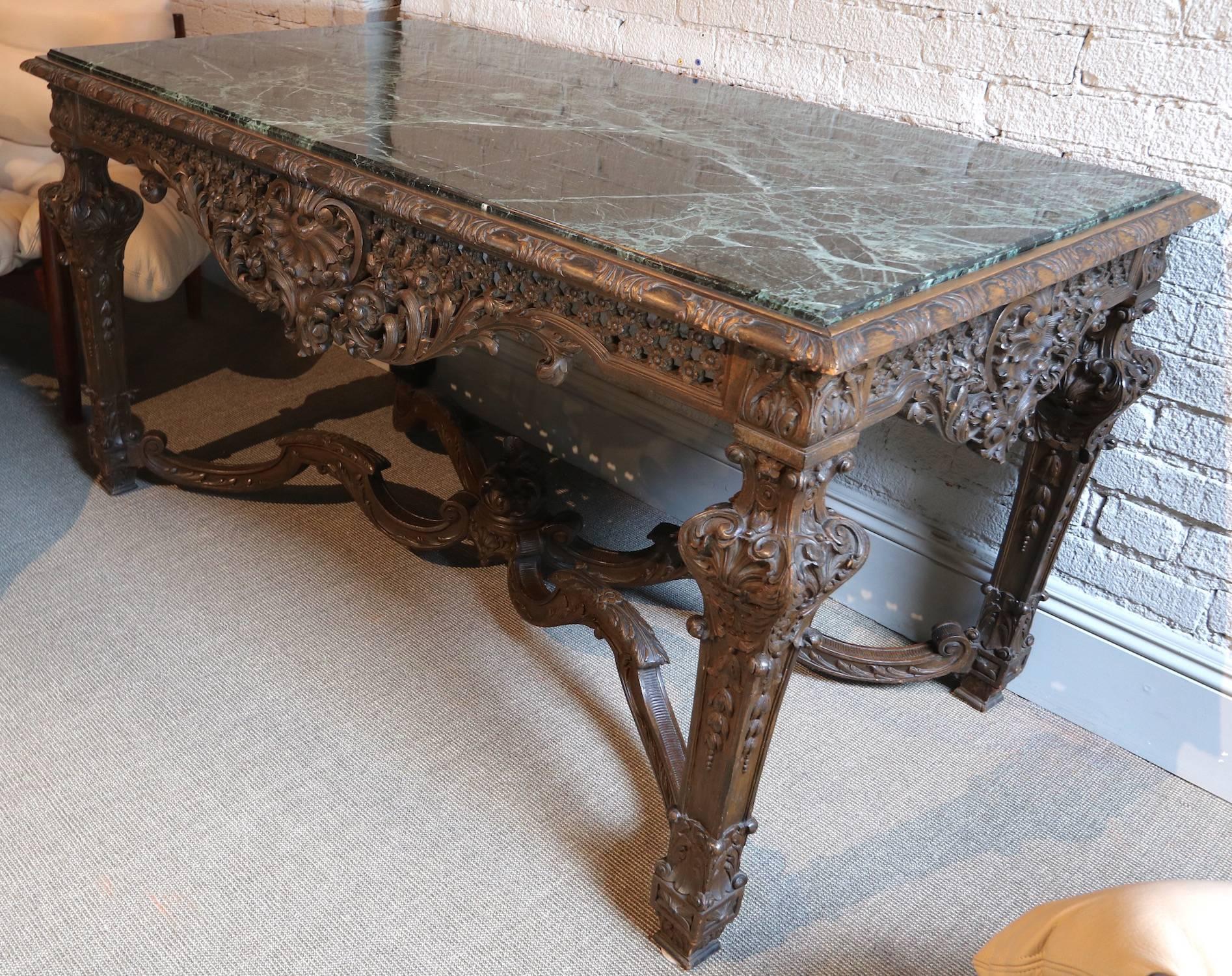 Impressive 1820s Louis XIV Italian carved wood console table with green marble top.

  