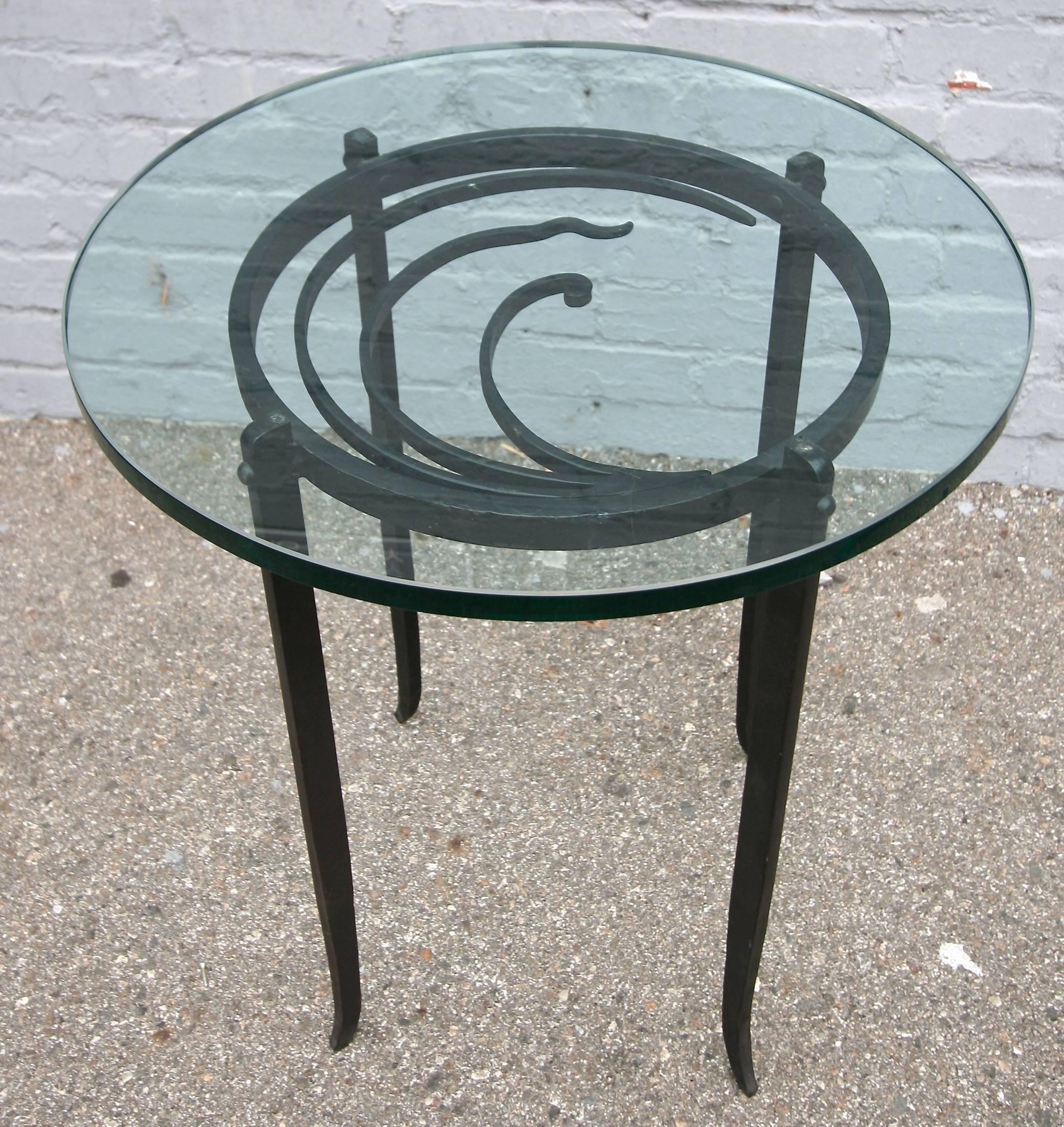 Pair of 1940s Art Deco side tables with beautifully detailed iron base and glass top.