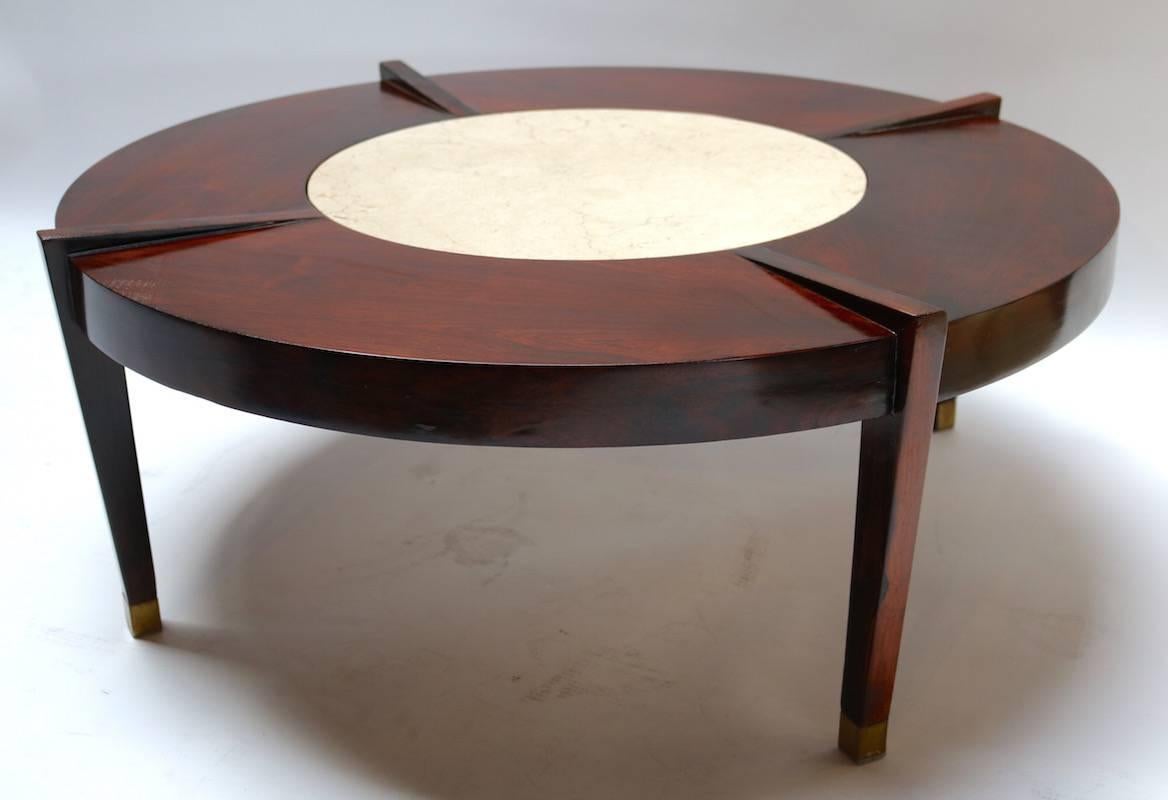 Round 1960s coffee table in Brazilian jacaranda wood with cream marble center and brass feet.