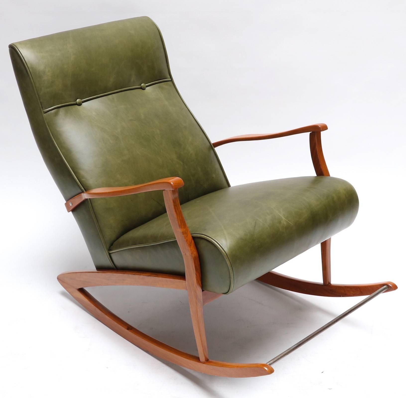1960s Brazilian wooden rocking chair upholstered in green leather.