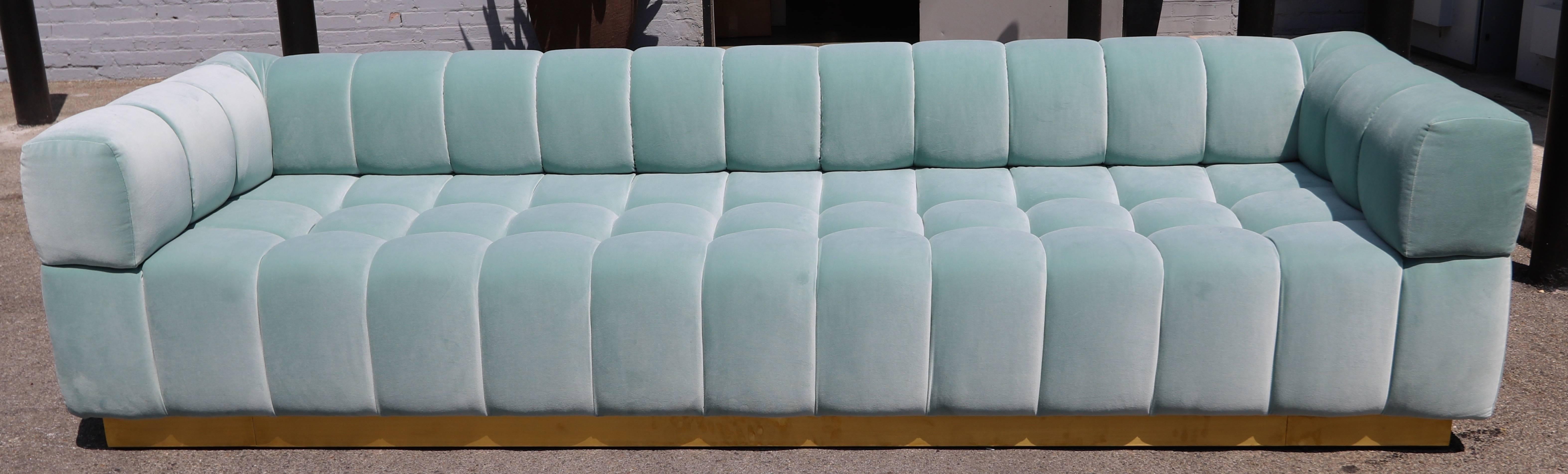 Custom tufted sofa with handmade brass base in aqua blue velvet.  Made in Los Angeles by Adesso Imports. Can be made in different colors and fabrics or a different metal for the base.