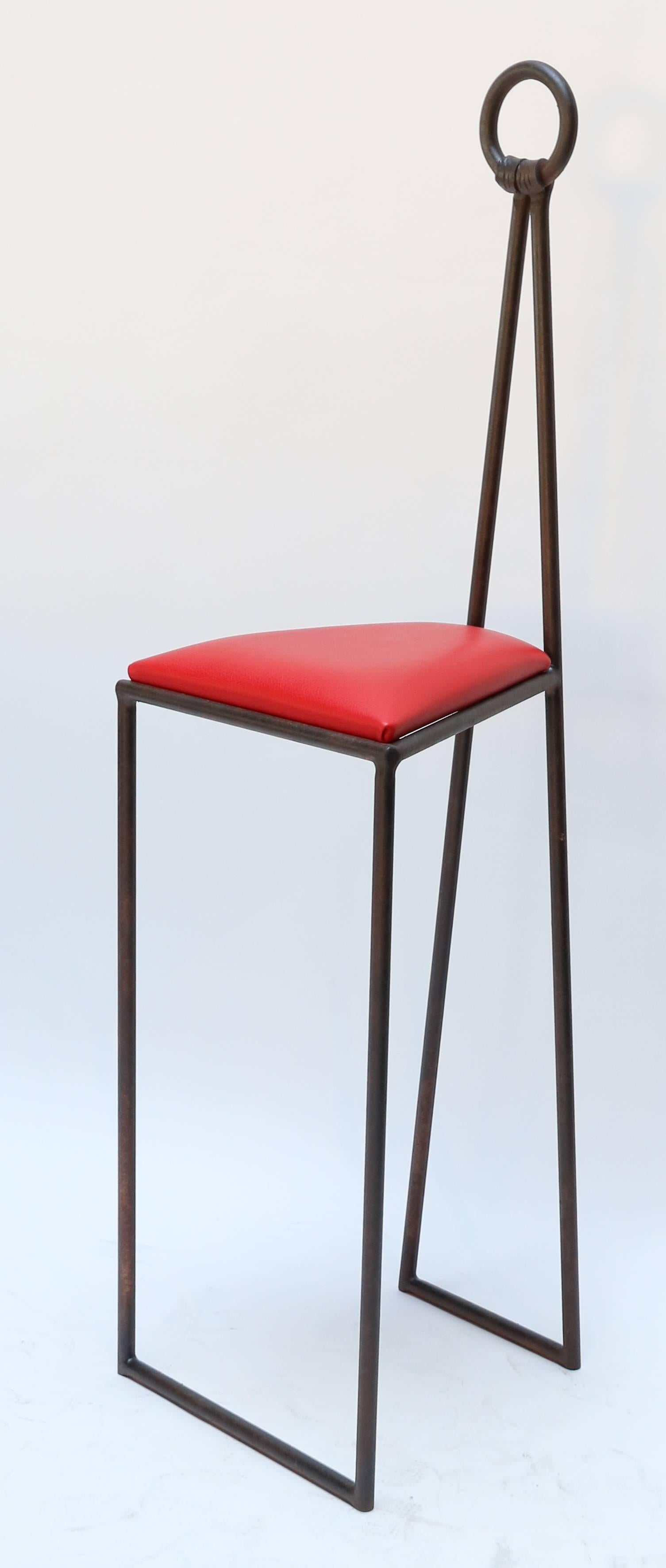 Custom iron bar stools with red leather seats.  Made in Los Angeles by Adesso Imports. Bar height and counter height available. Price and pictures shown are counter height.

Measures: Smaller counter height 45.25