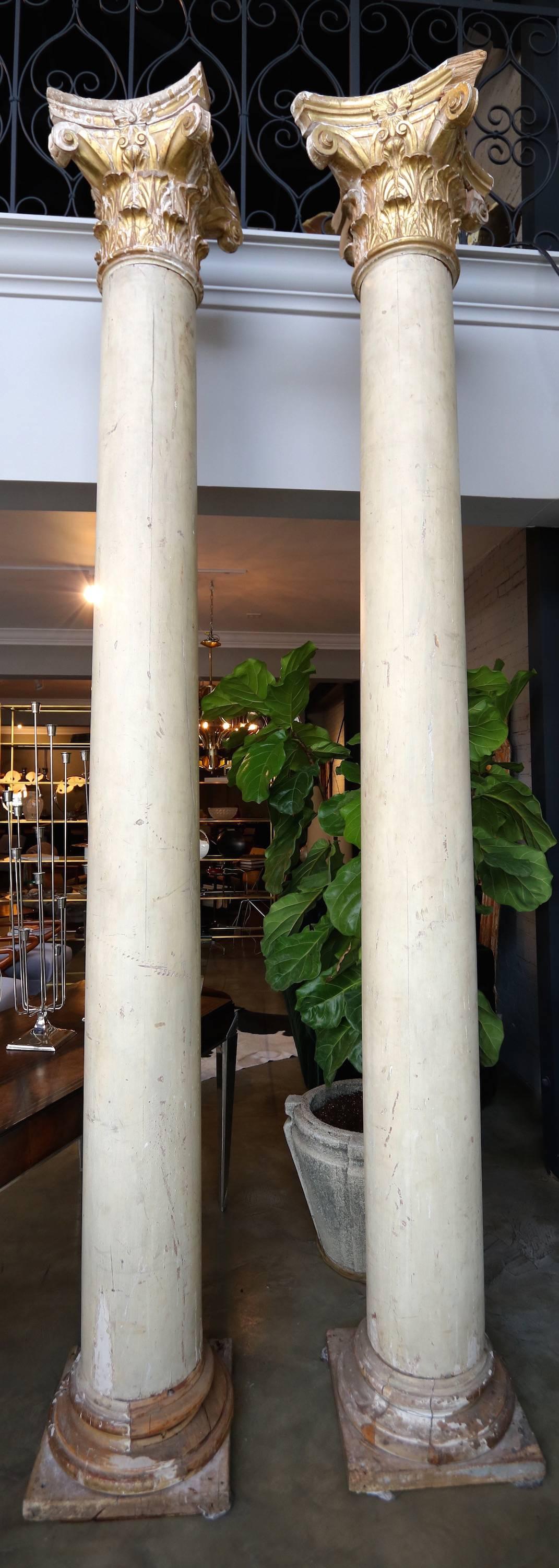 Pair of Italian decorative wood Corinthian columns, patina and gold leaf.