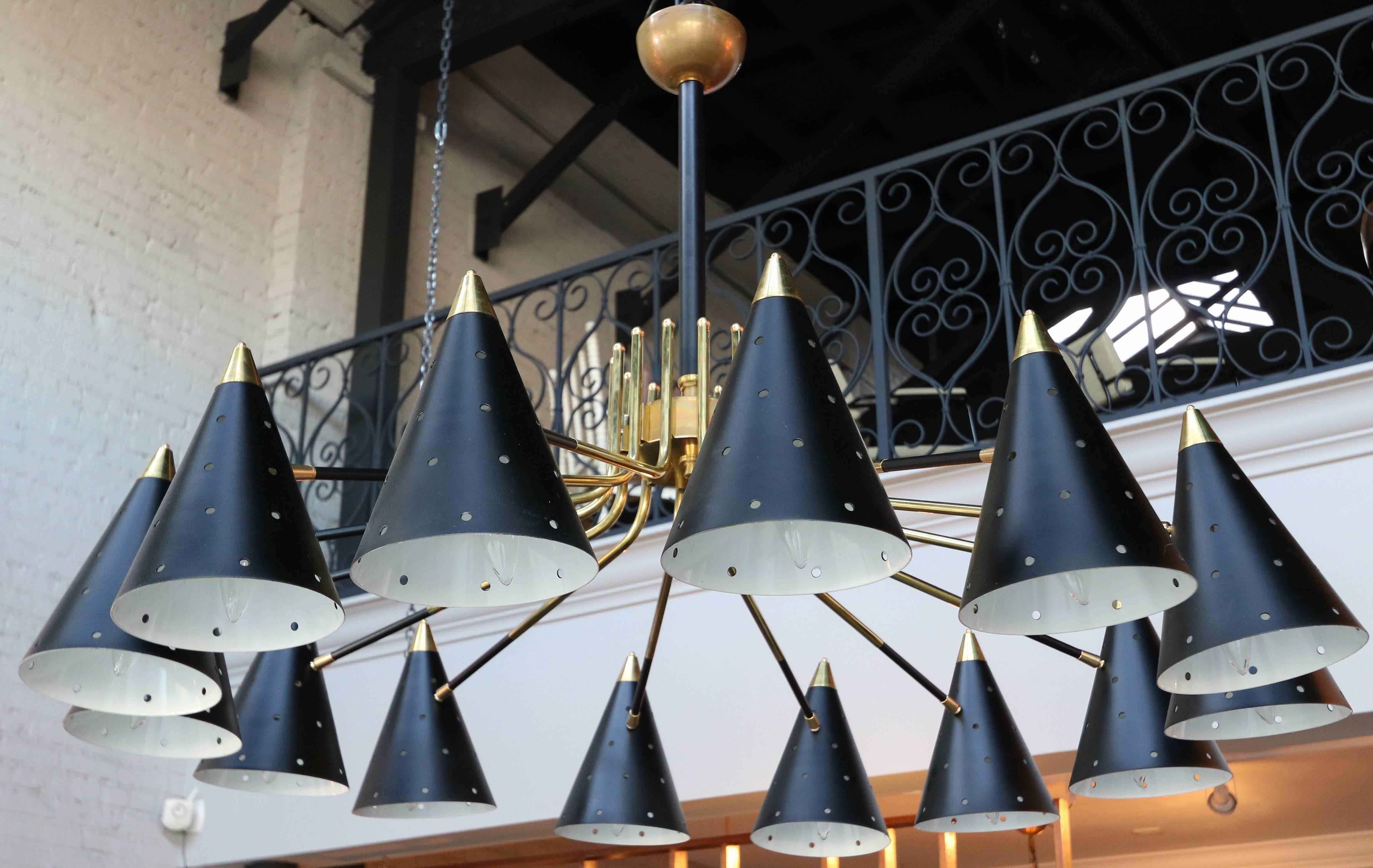 Midcentury style brass chandelier with 14 black perforated shades. Can be done in different sizes and configurations.