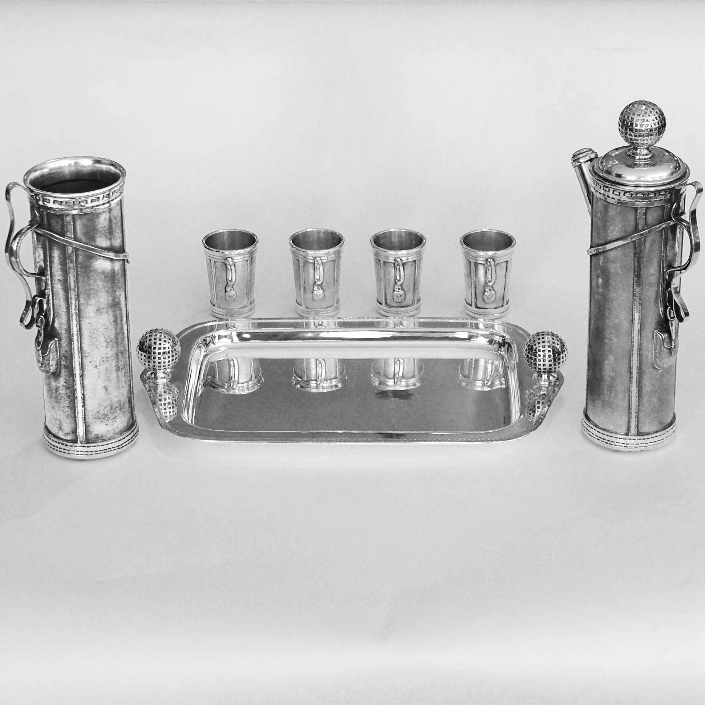 This is an original silver plated 1926 cocktail set manufactured by the American company, Derby Silver Company. Often described by historians as the first figural cocktail shaker, this set contains both the extremely rare cocktail pitcher, four cups