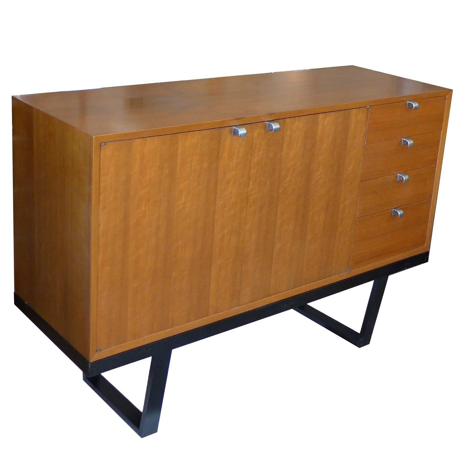 Wonderful all original walnut basic storage unit designed by George Nelson for Herman Miller in 1946. This unit features four drawers and includes a two-door section with the original adjustable shelf. The unit itself is 24" tall. The total