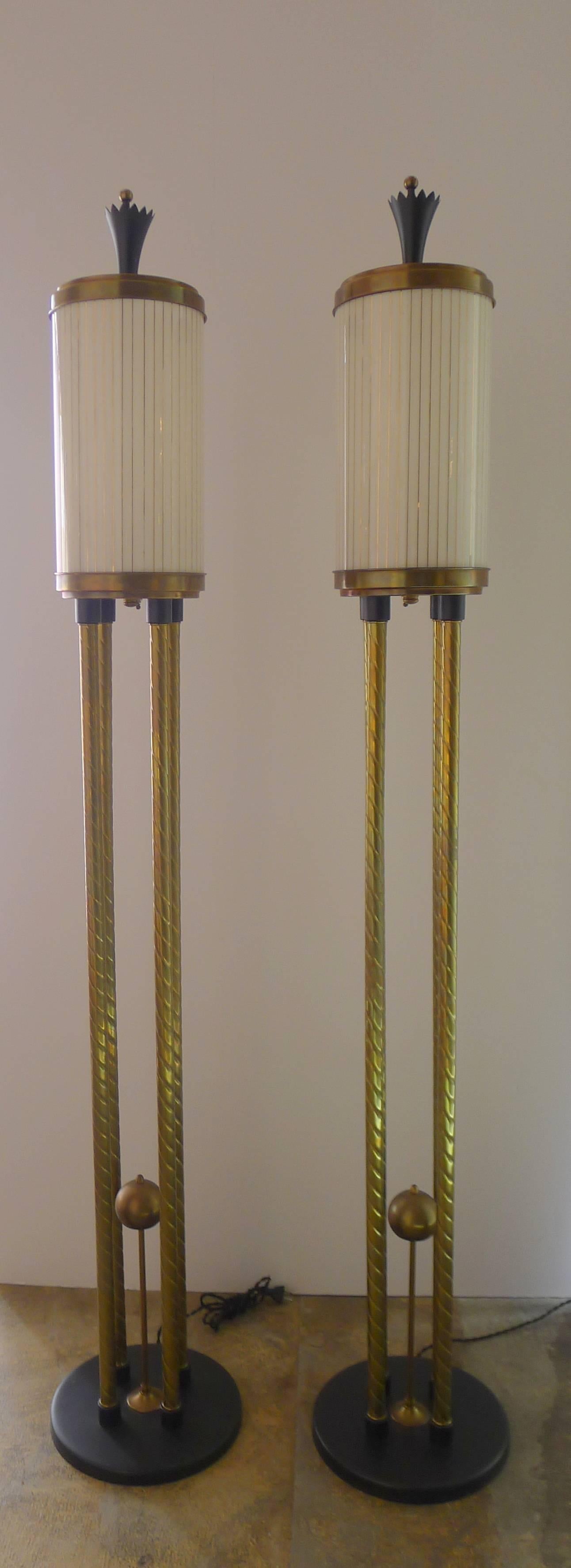 Pair of unusual brass torchieres with white glass and gold striped shades supported by turned brass supports.  First two photos are more accurate for the softer patina/coloration. 
