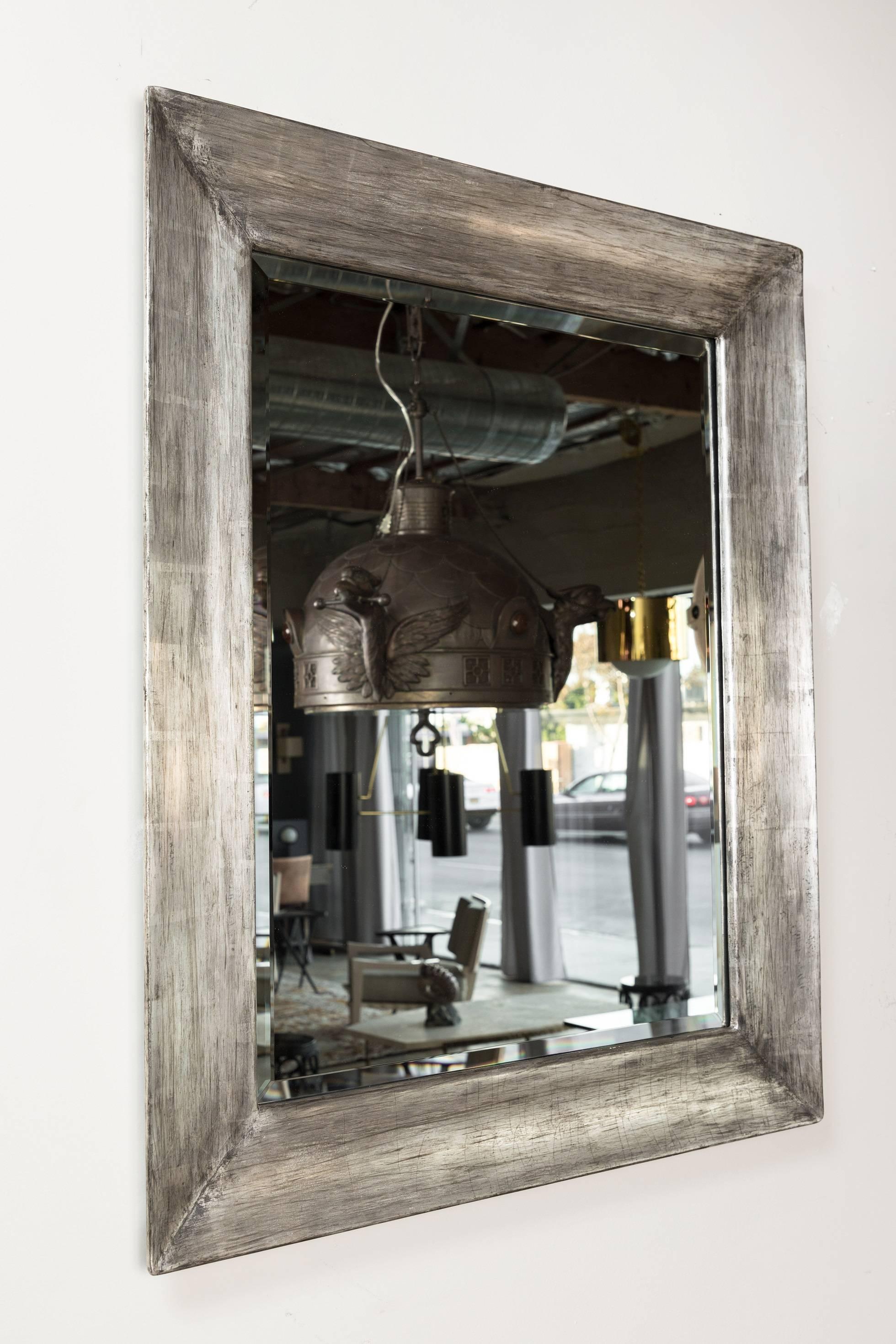 Paul Marra distressed silver framed mirror. Wood-framed with a distressed smooth silvered finish. Finish is smooth with natural imperfections varied throughout. One in stock as shown.