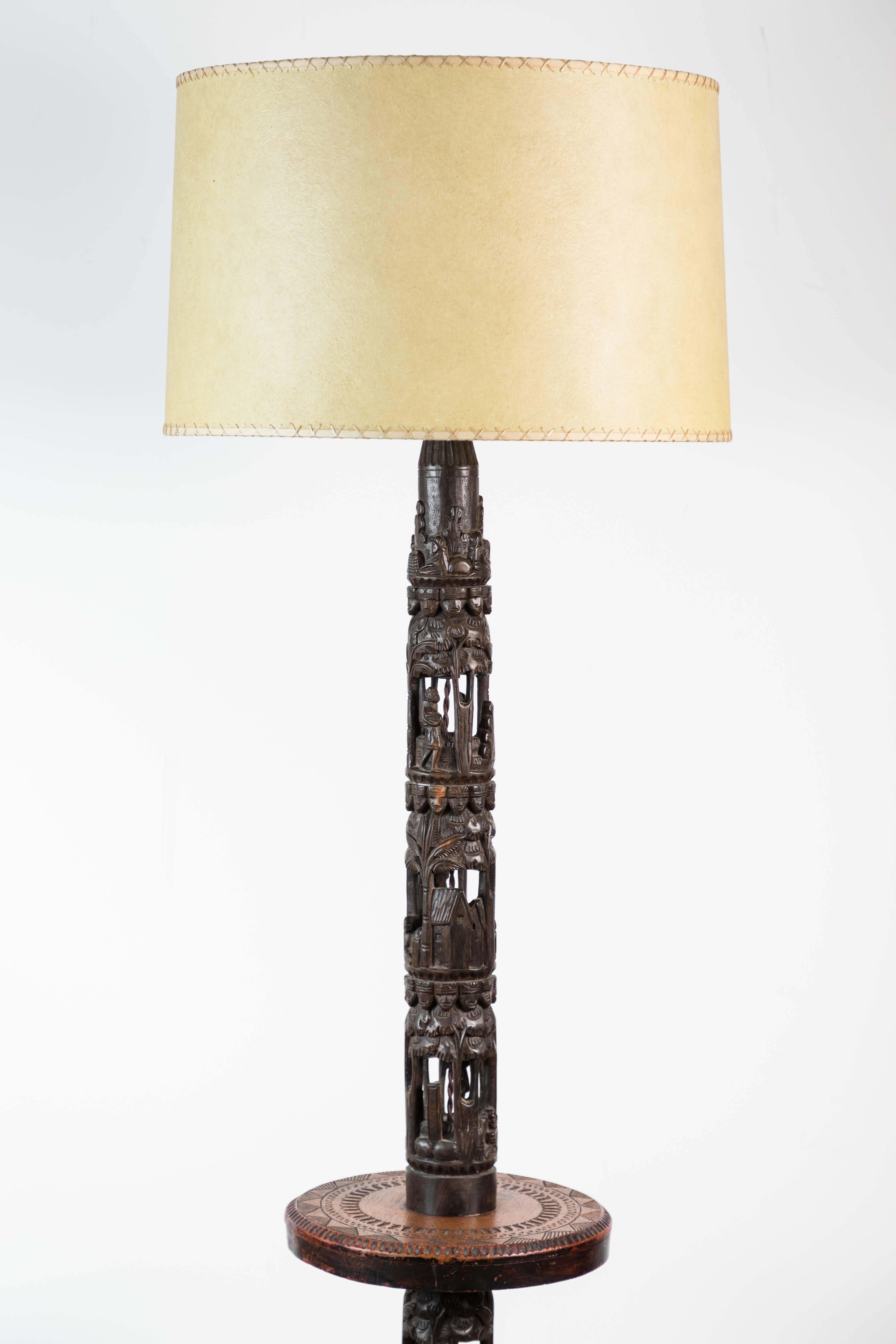 Beautiful floor lamp of African hand-carvings assembled into a floor lamp in France, mid-20th century.
Fertility symbolism throughout. Intricate details hand-carved details. Unknown African regional tribe. New wiring and new custom laced banded