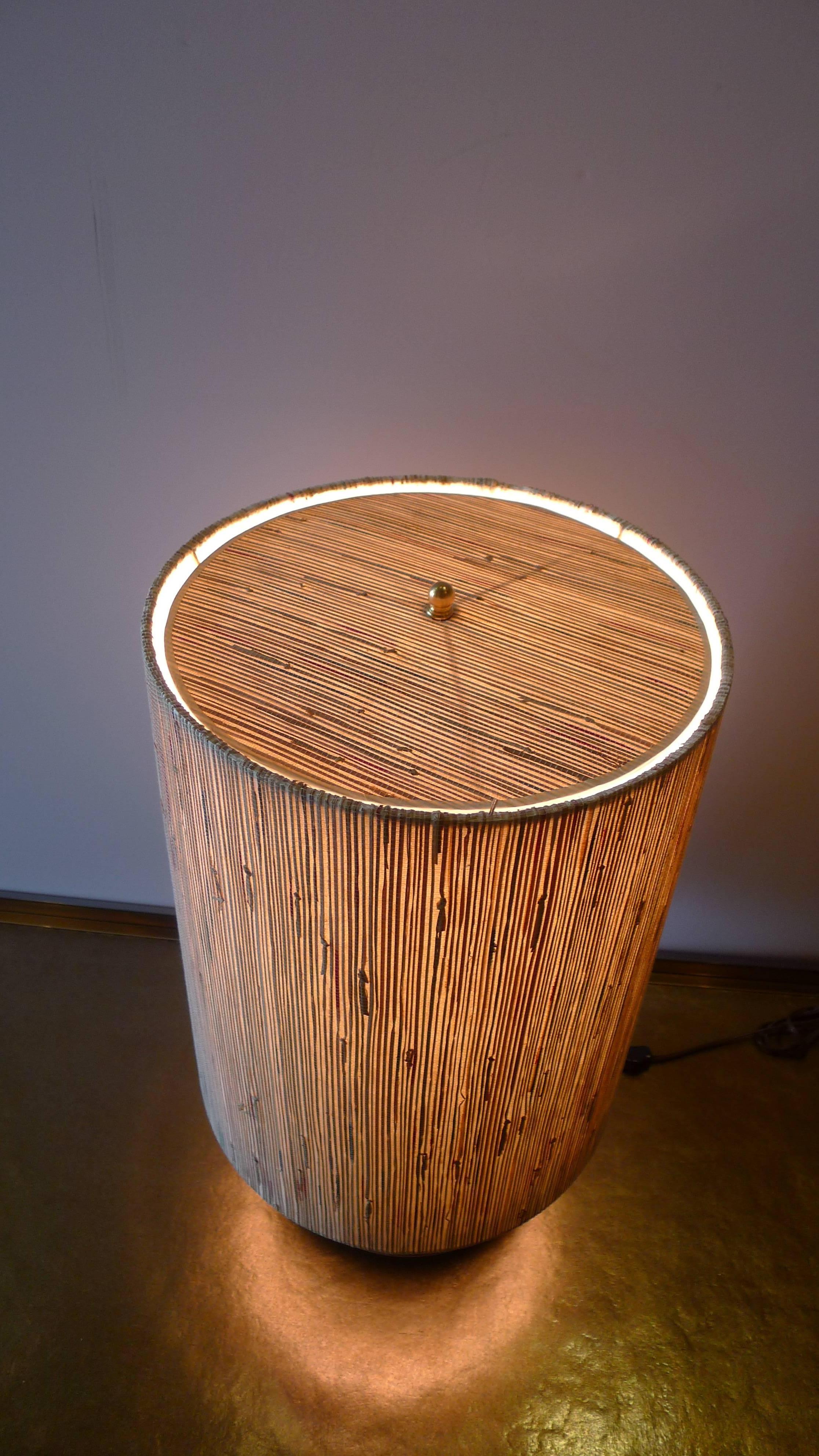 New modern brass table lamp with custom grasscloth shade by Paul Marra. Currently a pair available, or by order. The custom shade is made of grasscloth in subtle colors. The new electrical has online switch. The brass is unlacquered, will age over