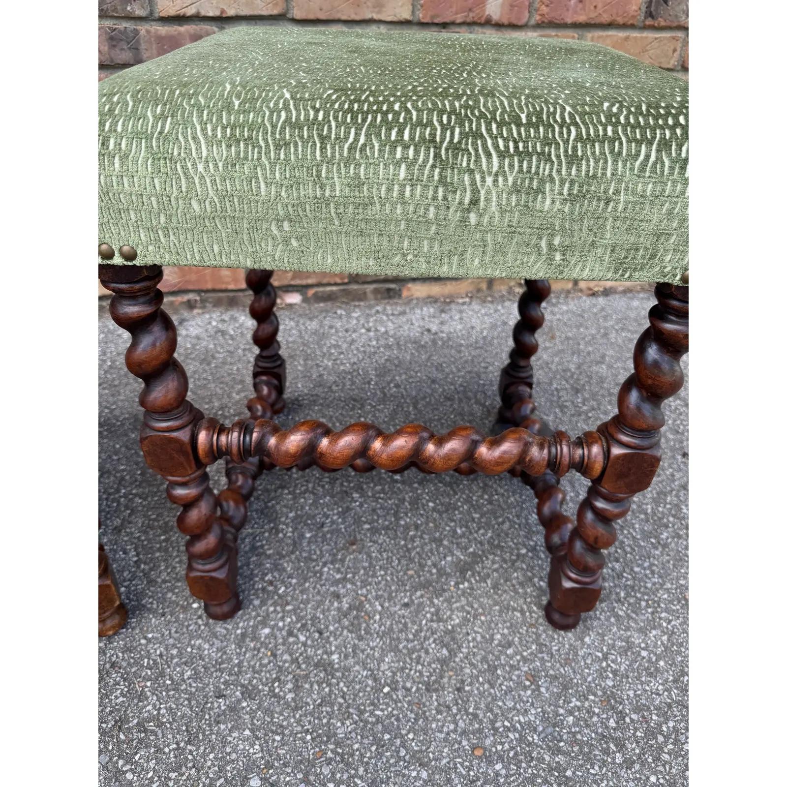 Beautiful antique newly upholstered set of stools! The fabric is a stunning green, crushed velvet material. The base is solid, hand carved wood, rich brown color that pairs wonderfully with the green fabric and brass nail heads. These would look
