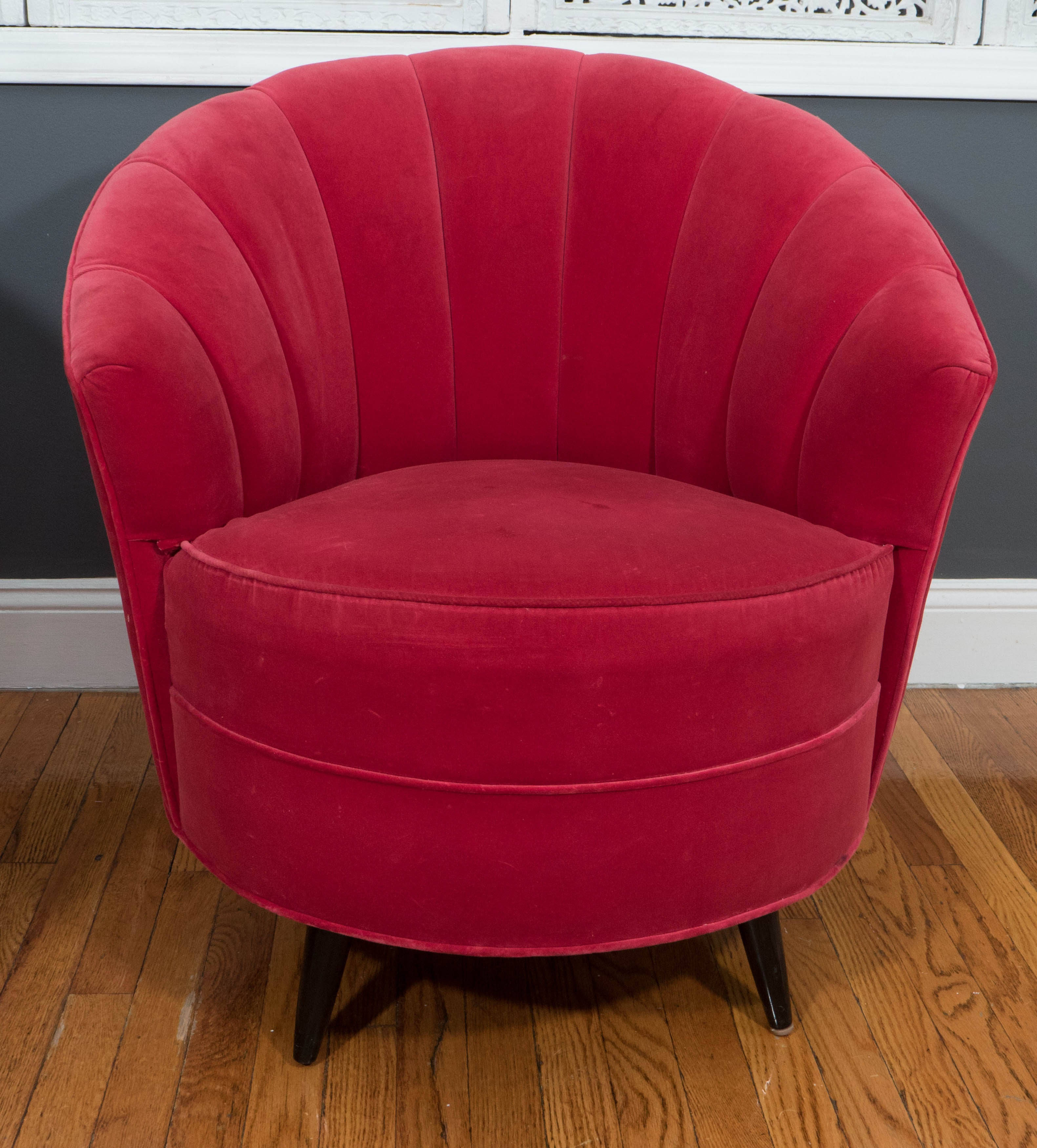 Pair of 1960s red velvet channel back swivel chairs.