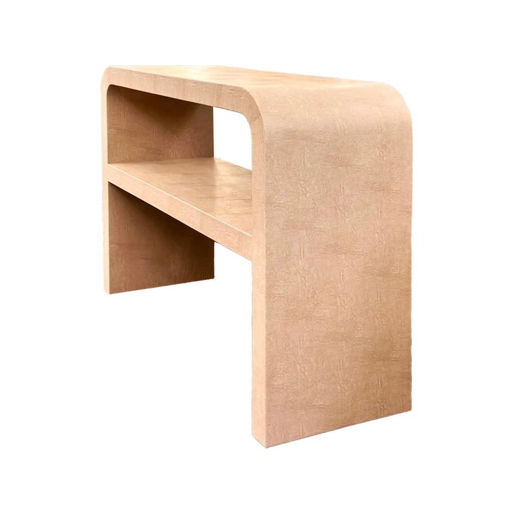 Elevate your interior with this Custom Leather Wrapped Waterfall Console, available exclusively at Venfield.

This piece features a sculptural waterfall silhouette with seamless curves and a spacious integrated shelf for functional styling. Wrapped