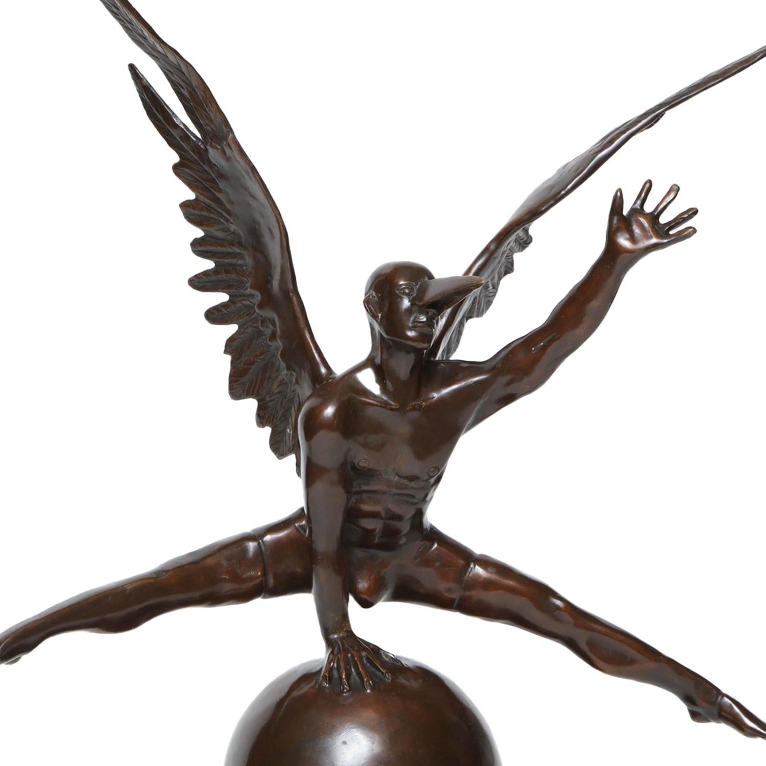 Created by Mexican artist Jorge Marín, this bronze statue illustrates his signature themes of balance, flight, and mythic masculinity. A muscular, winged male figure perches with elegant strength atop a polished sphere, legs extended in a poised