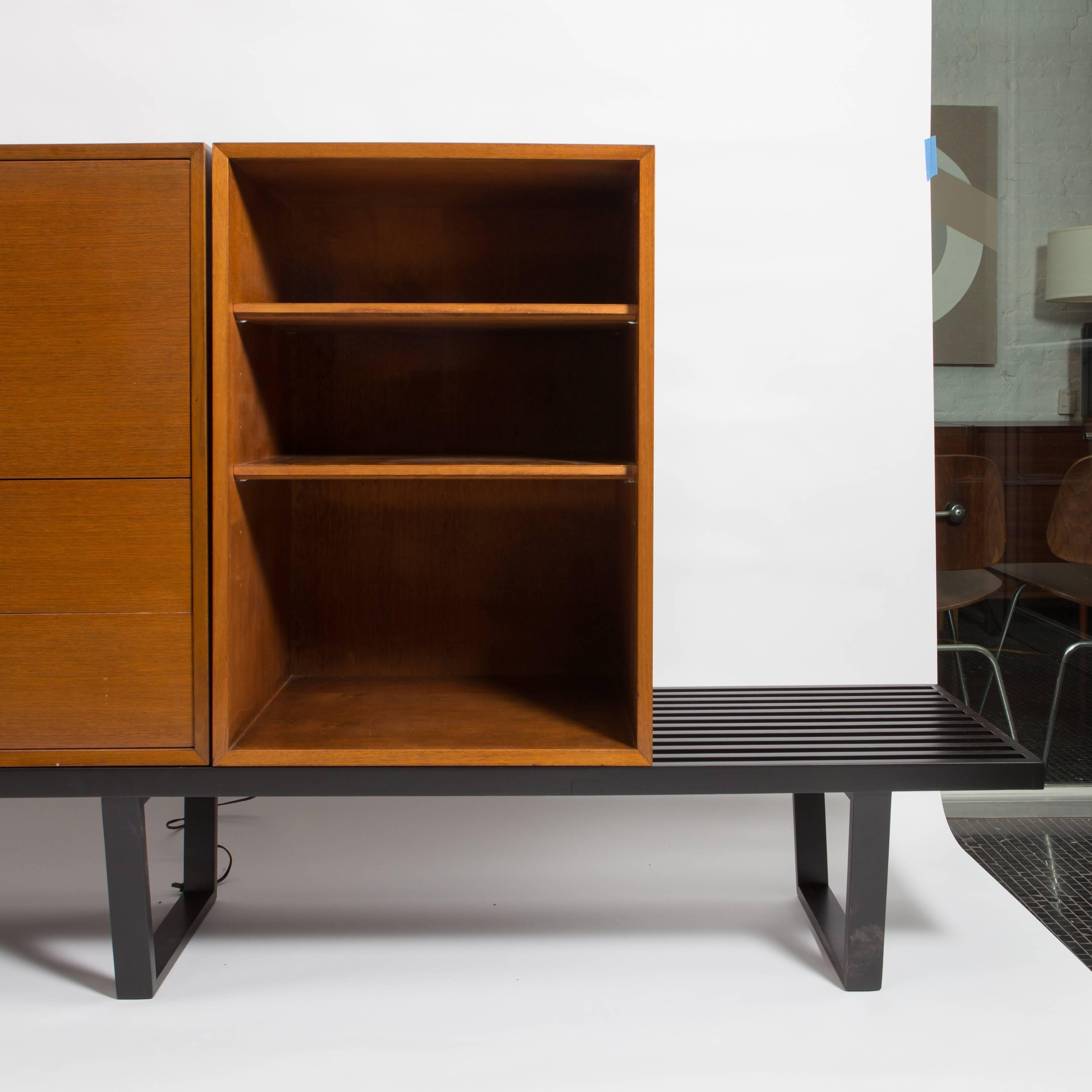 George Nelson walnut secretary and bookcase on extra long black bench, mfg. Herman Miller, 1950s. Three pieces sold as one unit.