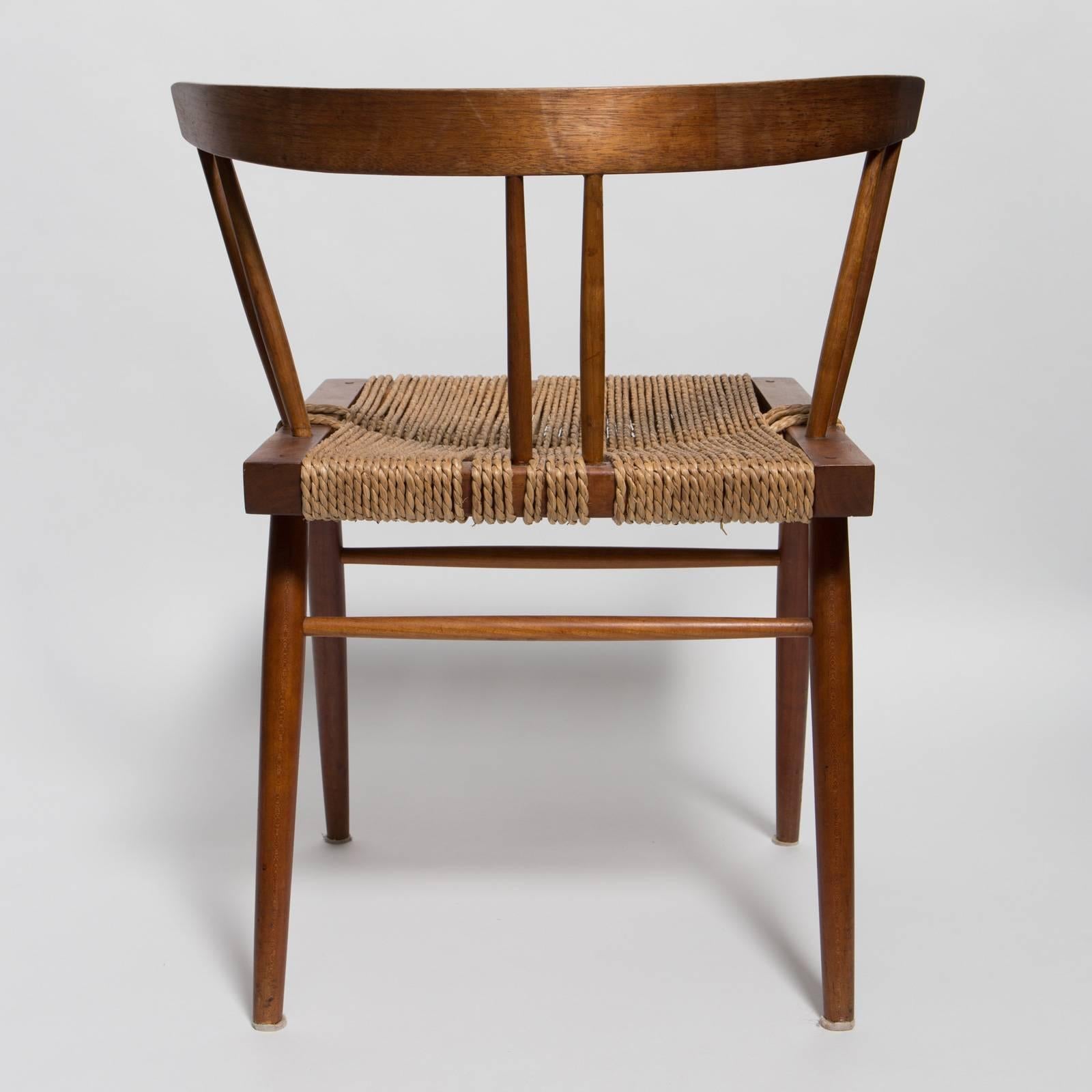 George Nakashima solid walnut dining chair with woven grass seat in beautiful original condition.