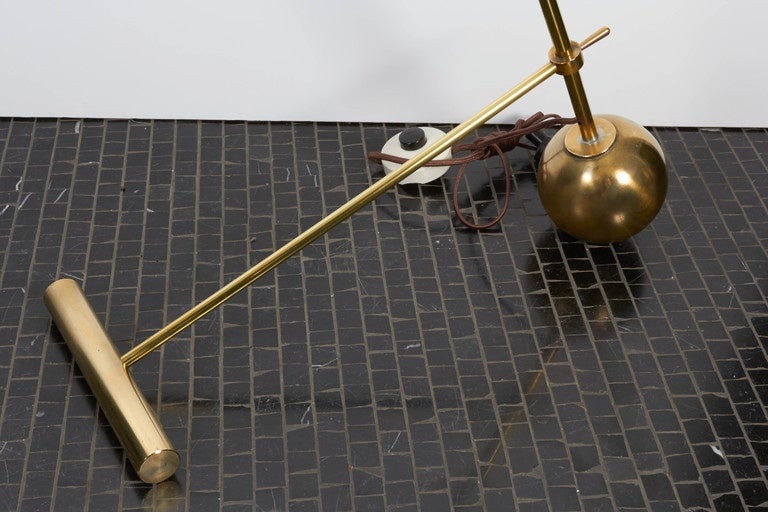 Italian, brass and steel floor lamp in the style of Arredoluce, circa 2015, with interesting counterweight base with solid brass ball and T joint. Two available but sold separately-one has a black cone as shown and the other is red.