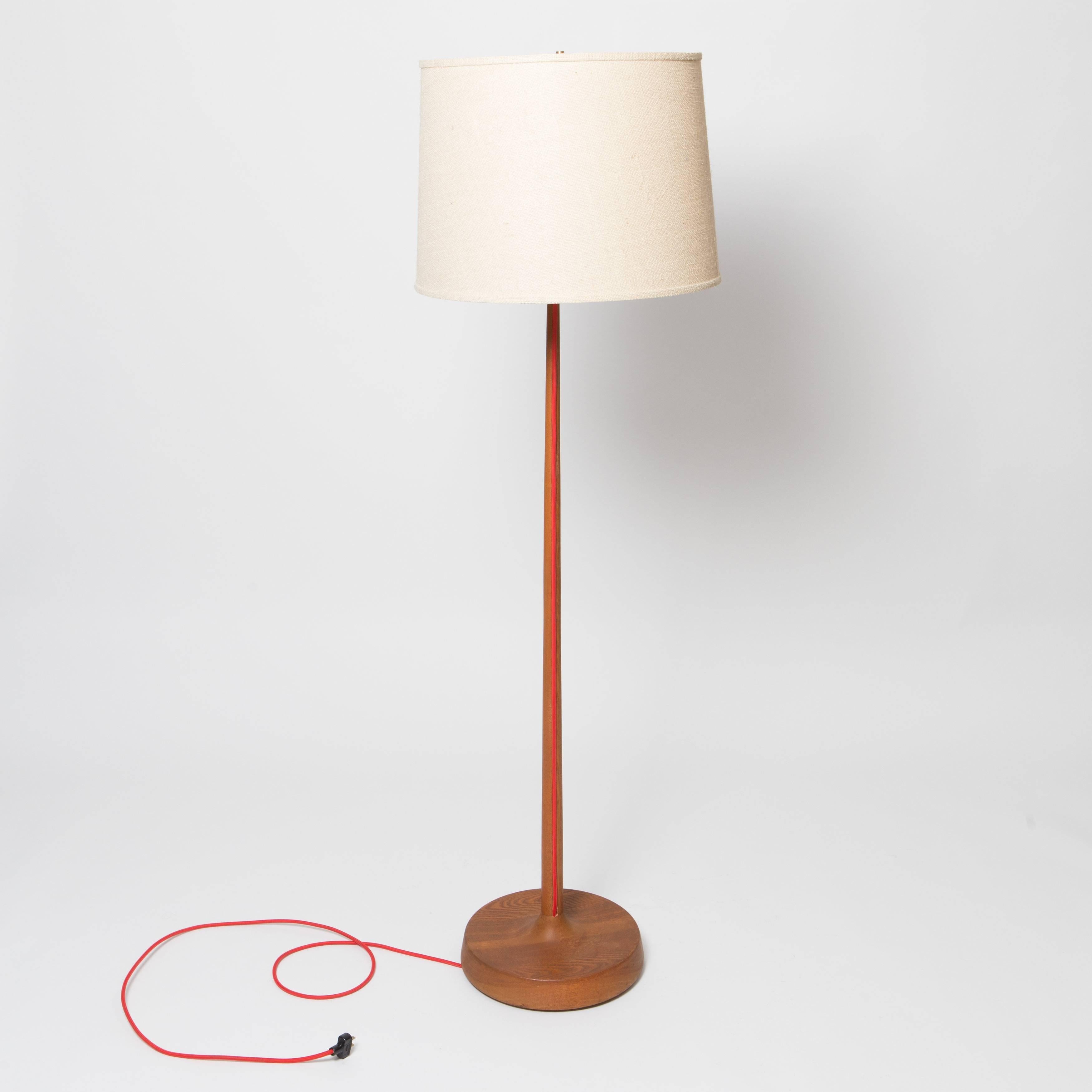 1950s solid oak floor lamp with exposed fabric cord.  Two lamps available-one with original rope shade and the other a contemporary burlap shade.  Diameter below is for the base.