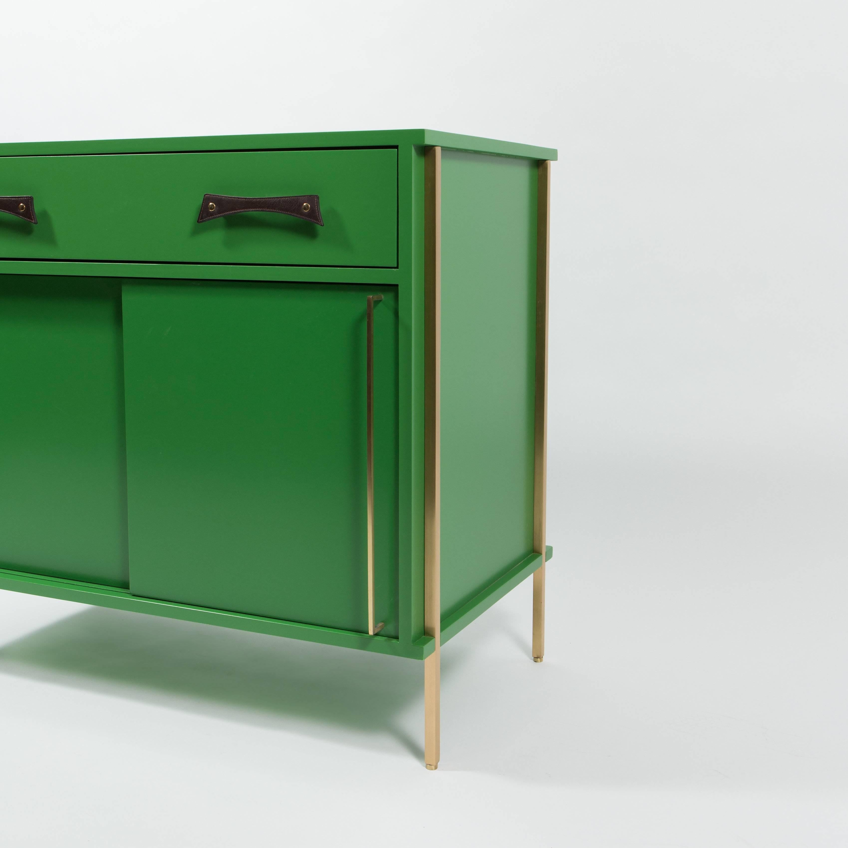 Made to order sliding  door cabinet with drawer in RAL Grass Green lacquer. Handmade leather handles on drawer by Jutta Neumann and hand made brass handles on doors.