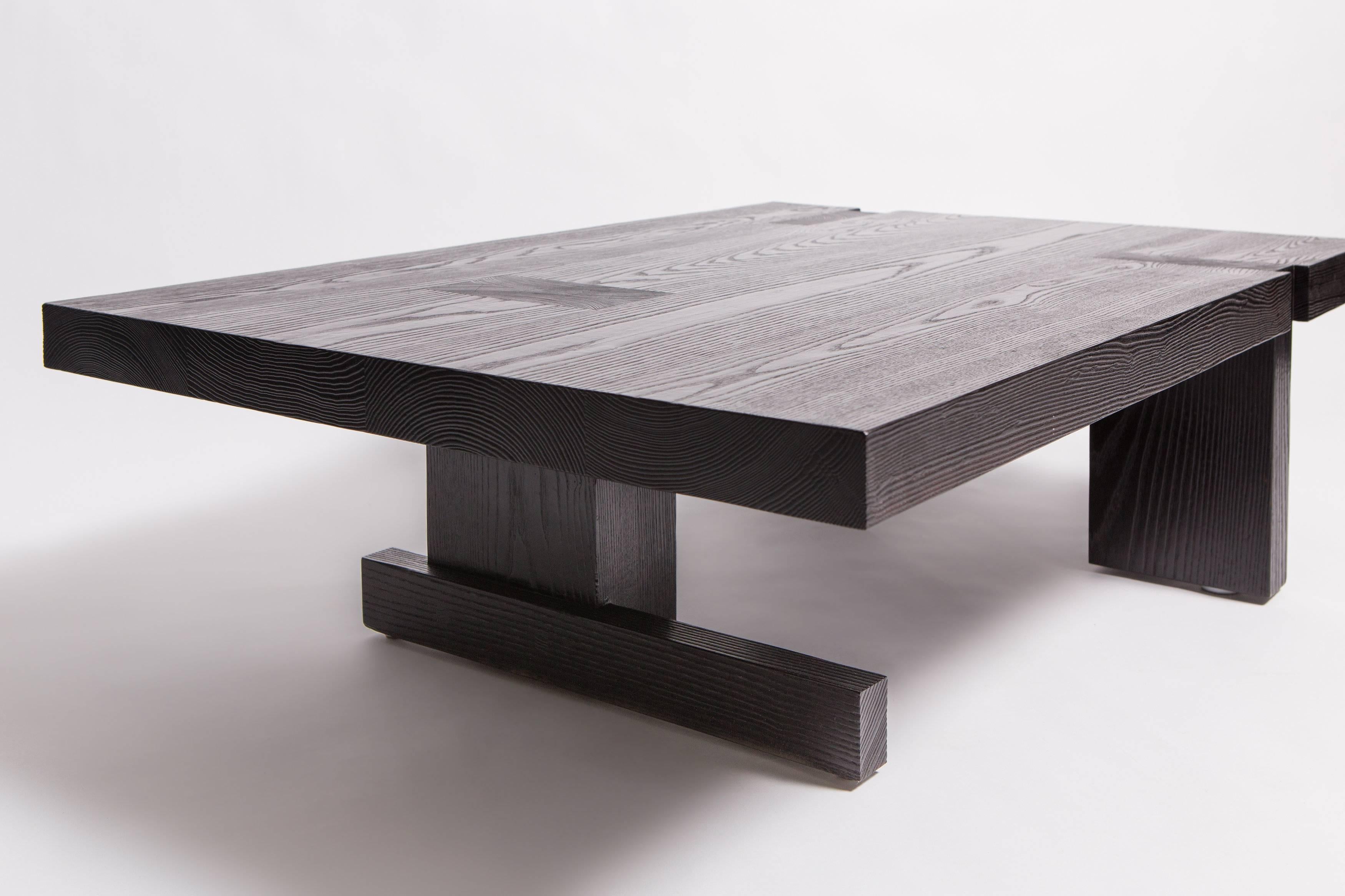 A very heavy and solid ash coffee table made by BDDW all with beautiful joinery. Everything is either doweled or tenoned together. The solid ash was charred with a torch to create the black finish and then finished in hand rubbed oil.
 