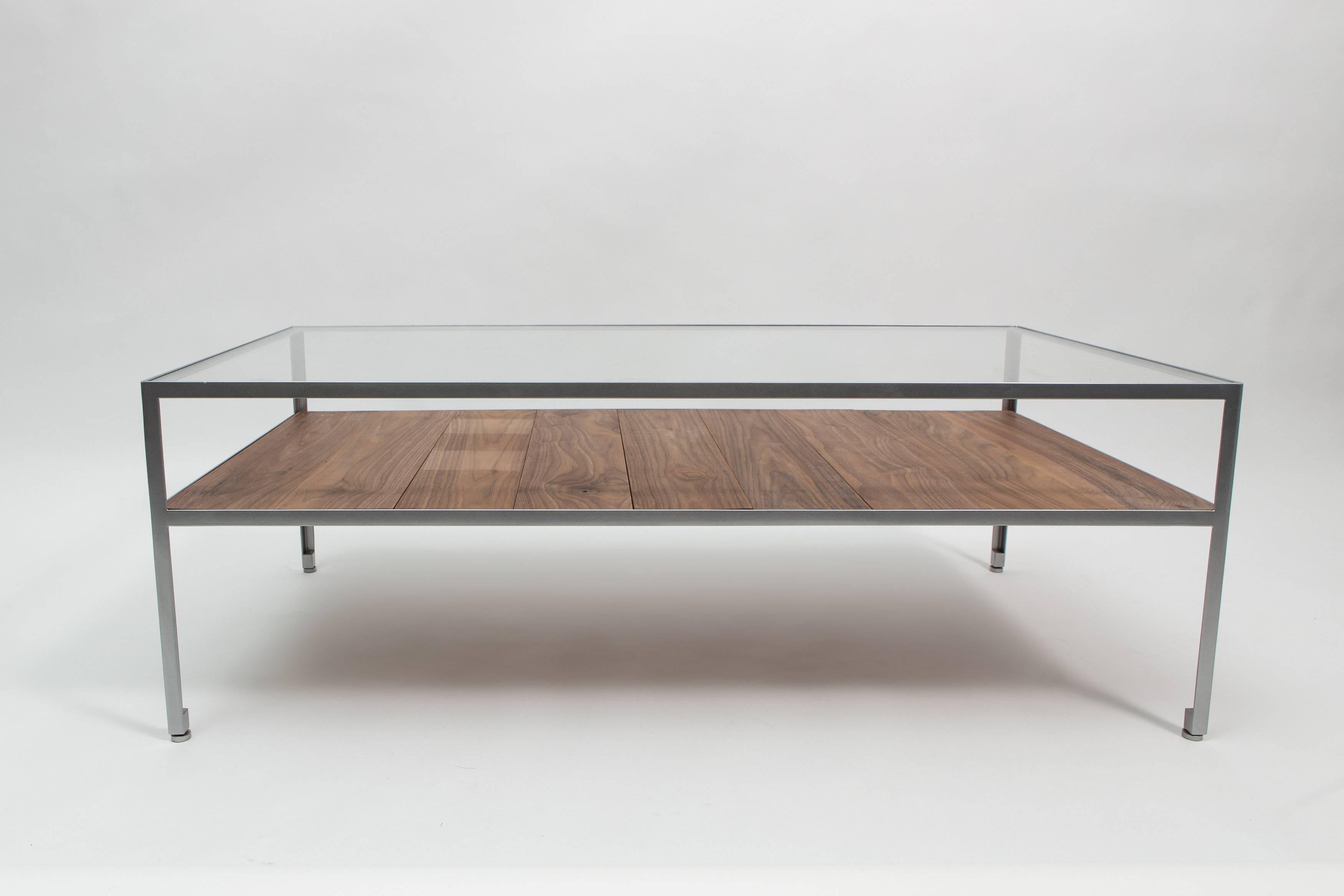 Angle steel coffee table with nickel frame, glass top and walnut slats.