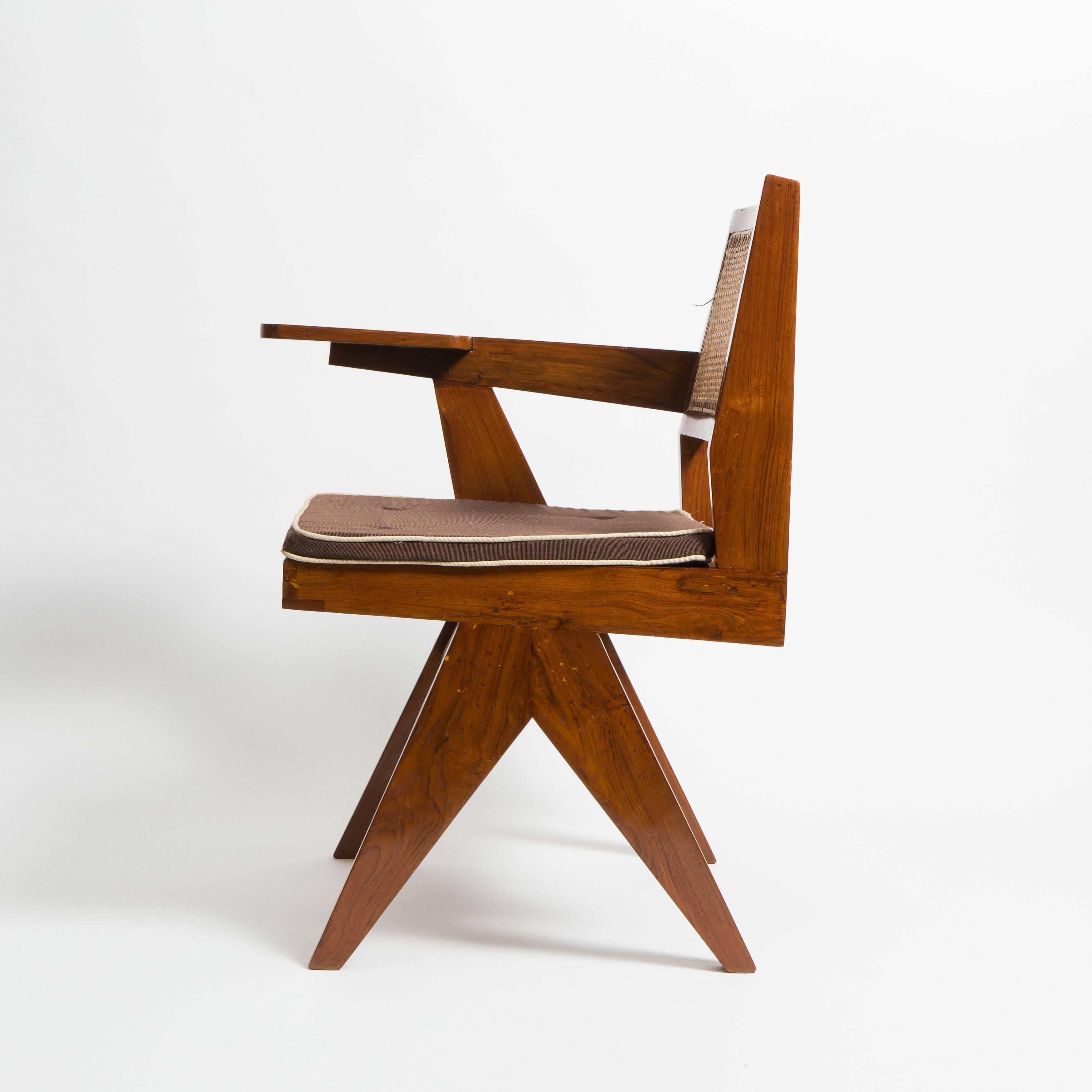 Pierre Jeanneret library chair which was designed for the Panjab University Library reading rooms but also for other libraries of the city Chandigarh. The chair is made out of solid teak and cane.

