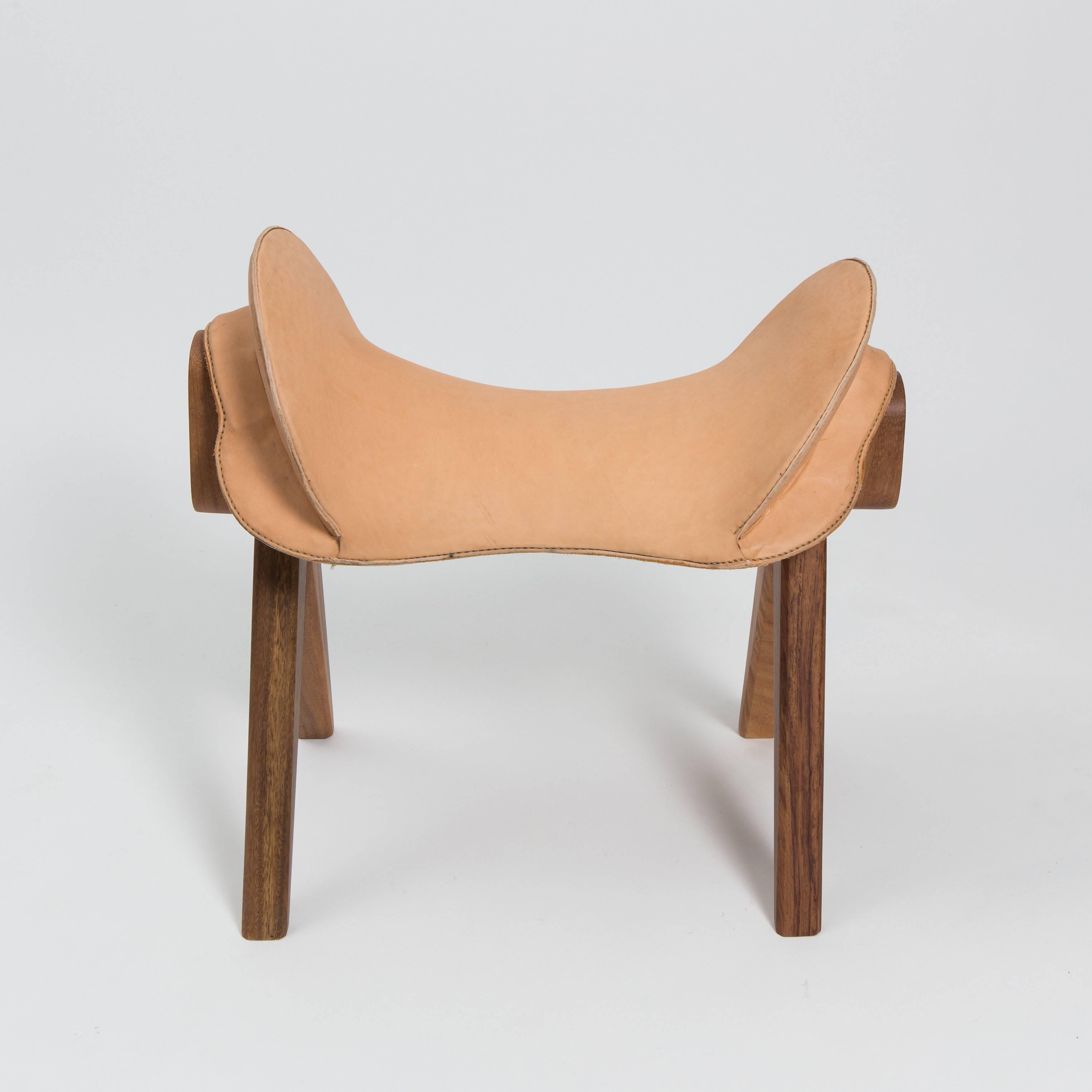 Saddle stool by Gabriela Valenzuela-Hirsch. Hand-stitched natural leather seat on solid carved guanacaste frame. Made exclusively for reGeneration for a show entitled “Two Mundos” which is currently on view.