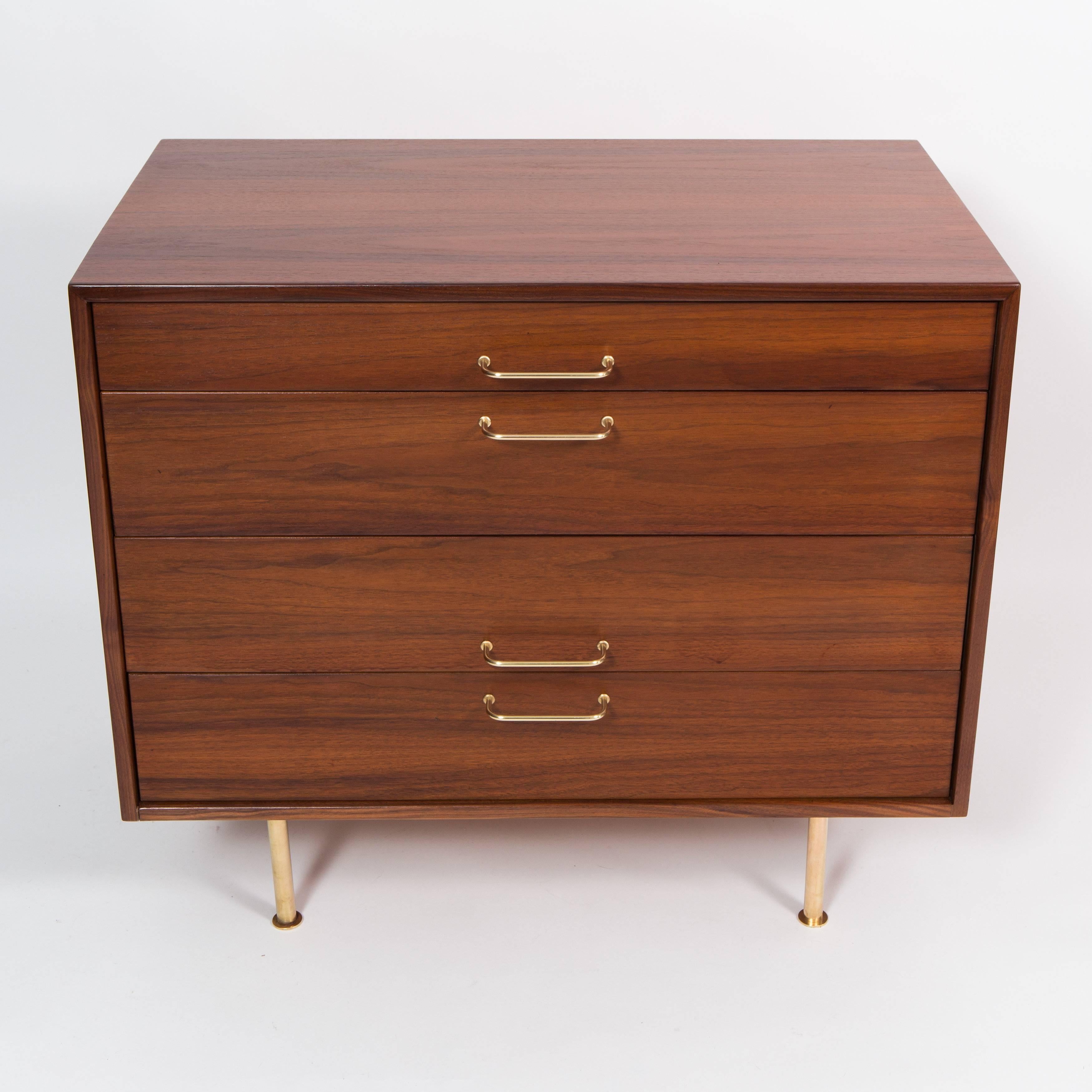 Beautifully figured walnut dresser on brass legs, 1950s.  Coordinating dresser with cabinet available separately.