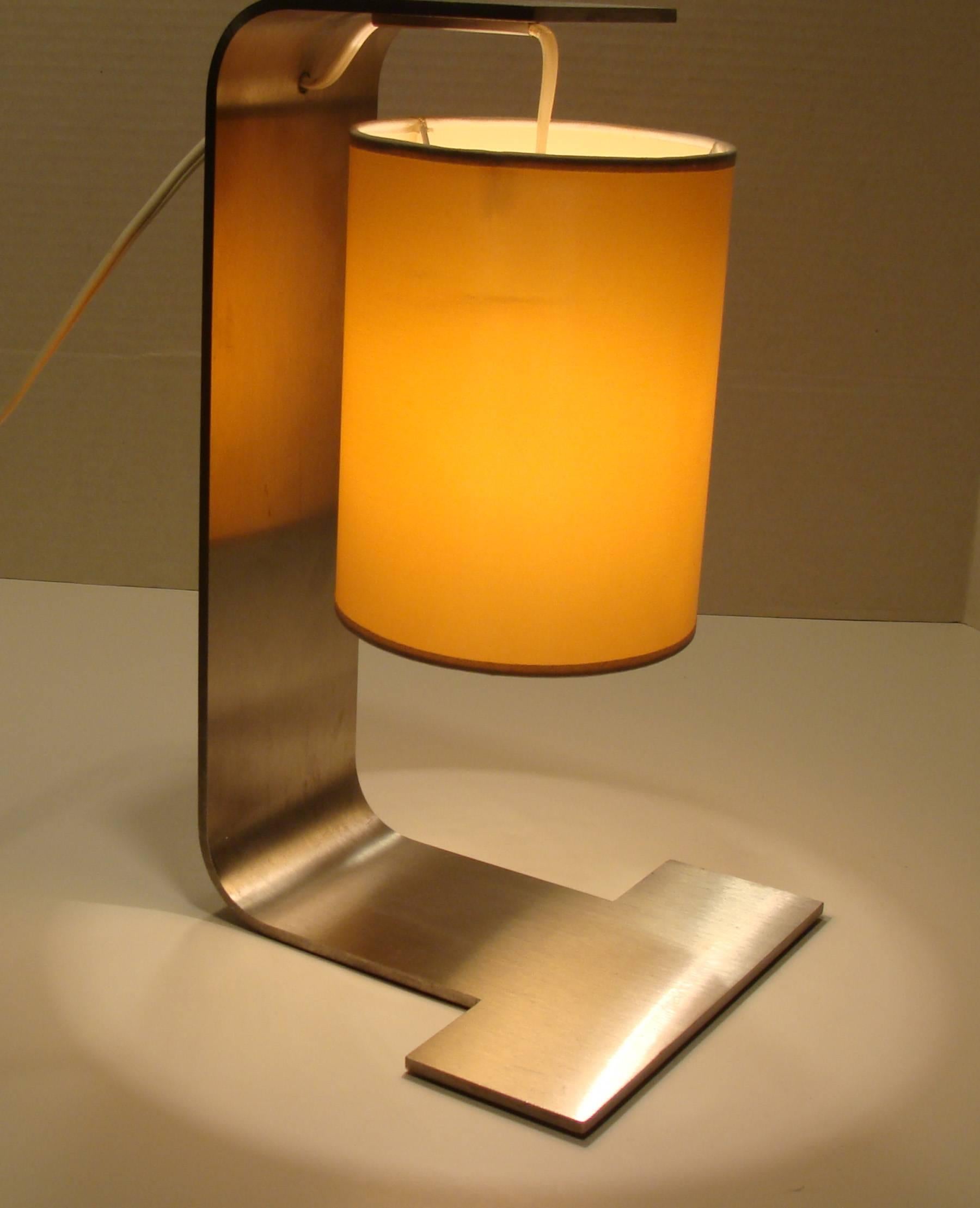 Exquisite modern design from French designer Christophe Delcourt.
Uses single lightbulb having chandelier socket. Brushed steel with Taffeta shade.