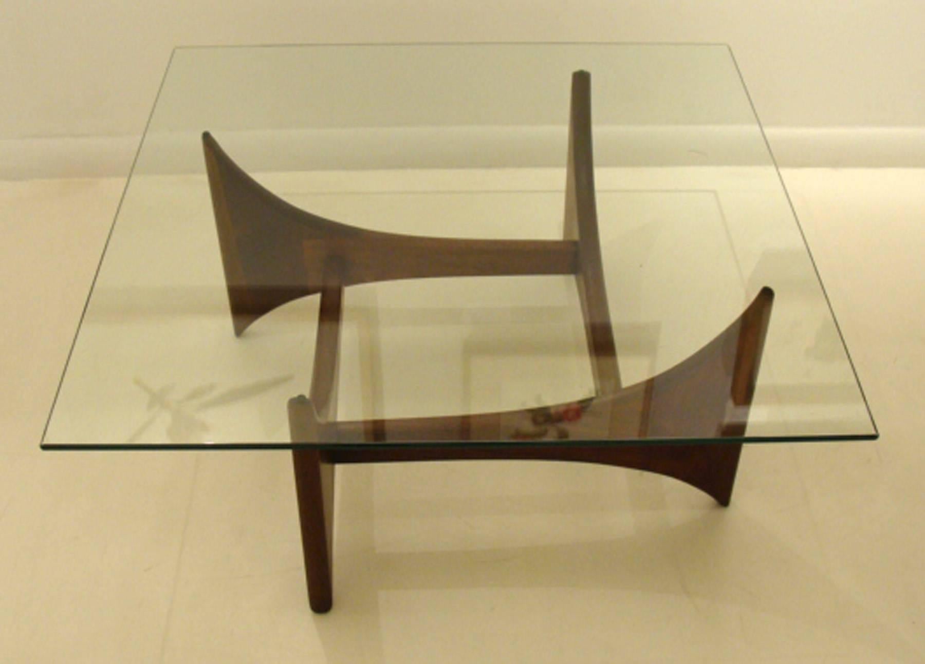 Pearsall sculptural coffee table in walnut with square glass top.