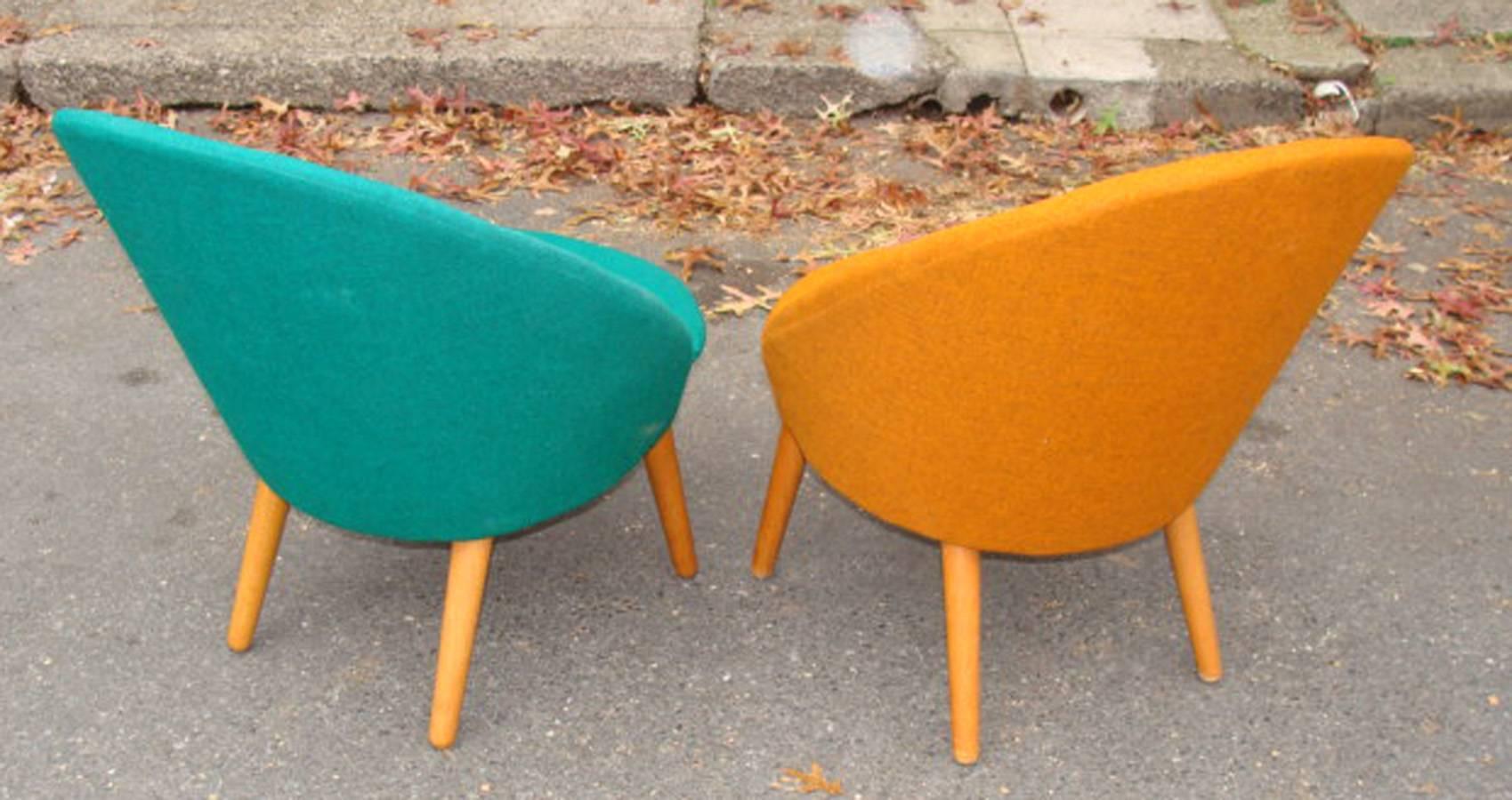 Pair of true Mid-Century Danish easy chairs retaining original wool fabric.
Matching frames, one in orange fabric and the other in green fabric. Light oak legs. Maker's labels on chair frames. Note: original fabric exhibits minor wear and slight