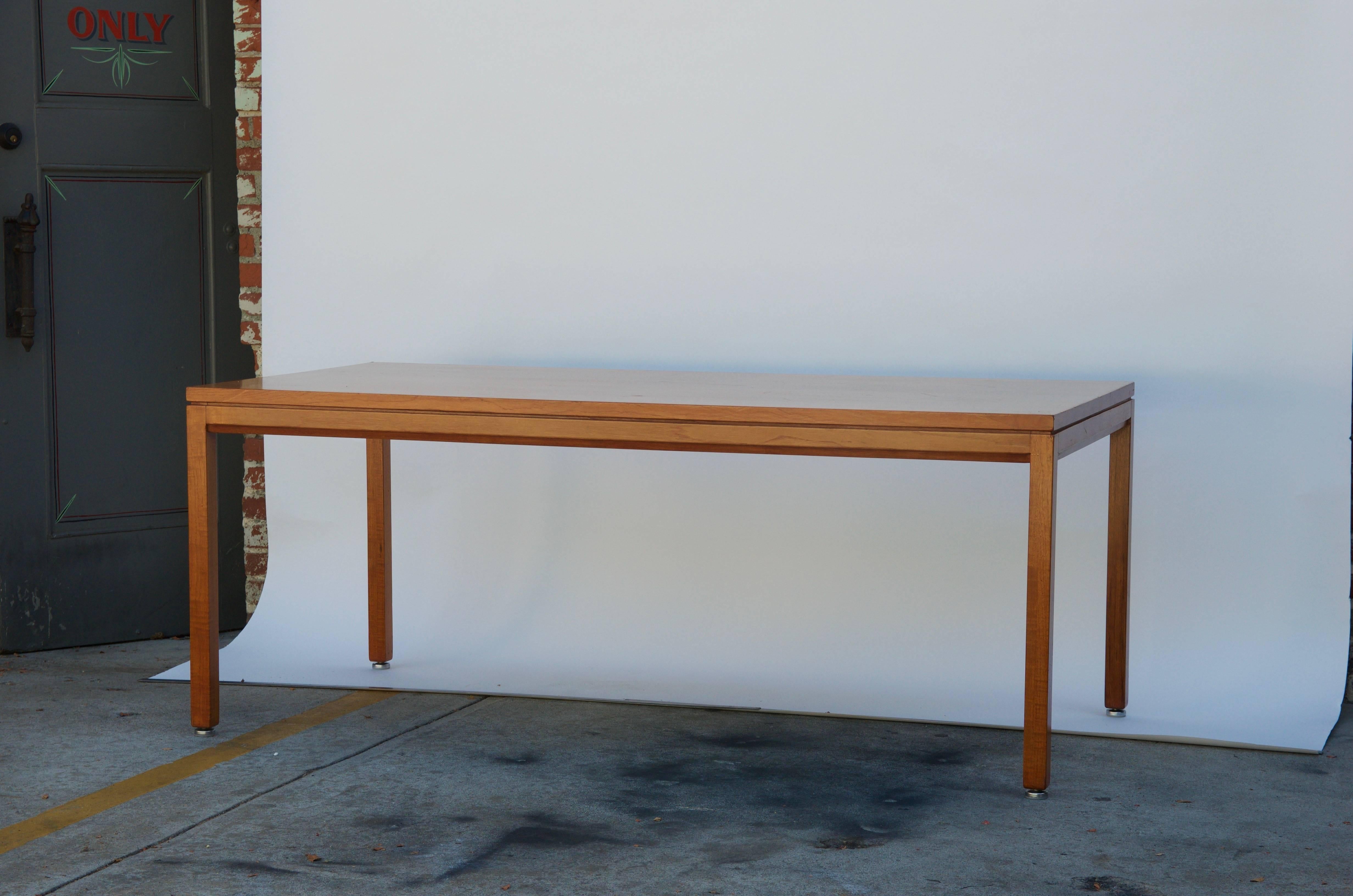 Impeccable blond walnut desk or library table by Jens Risom. The tag pictured is from the matching desk already sold. This piece was very well taken care of by its previous owners and is in excellent original condition.