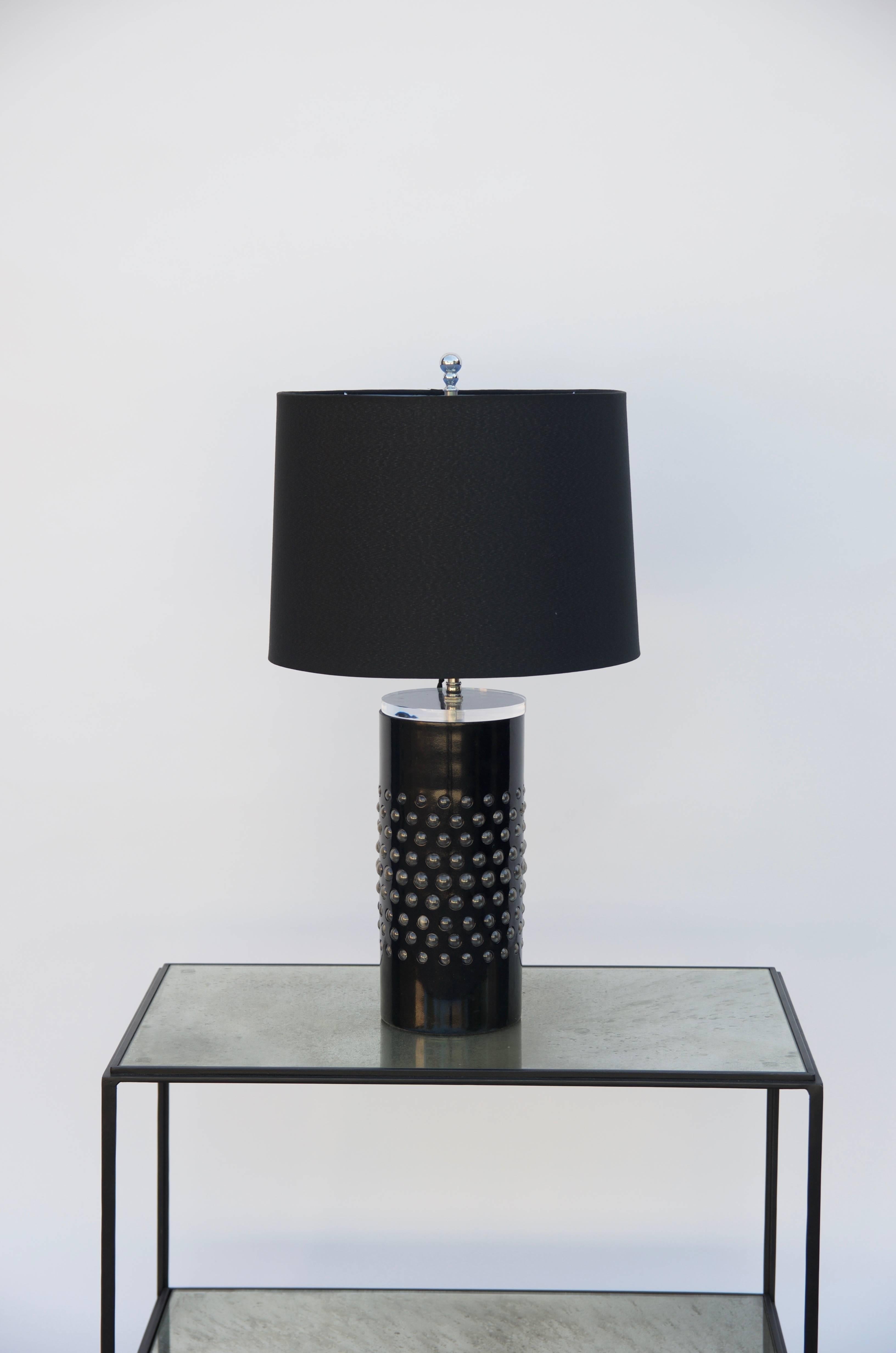 Pair of unusual textured glass cylinder lamps with custom shades, circa 1980. Rewired with custom black silk shades. The transparent top piece of the columns lets the light through the base glass ball openings.

Drum shade measurements: 13 in.