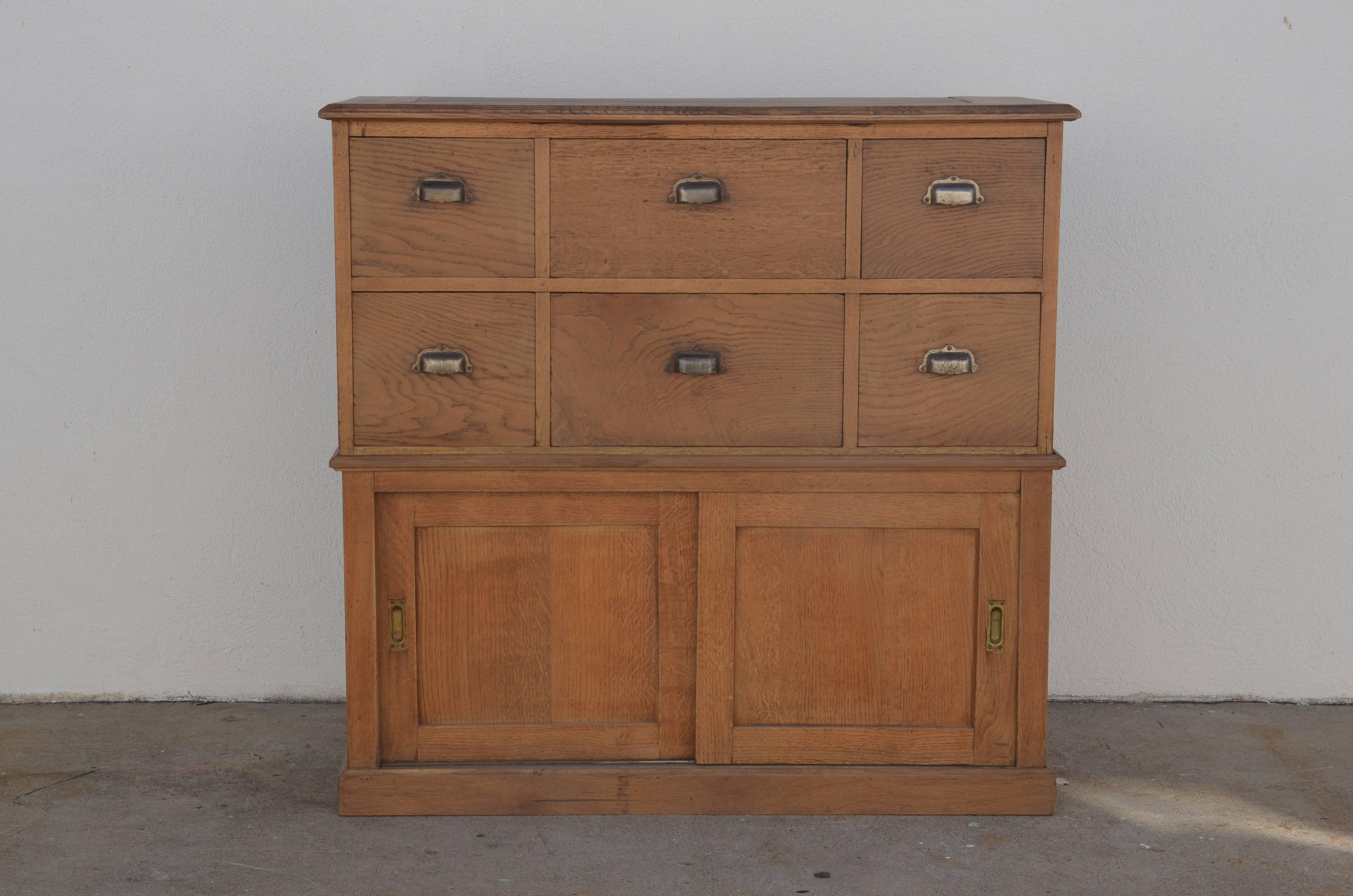 Solid patinated oak French workshop or apothecary cabinet. Original weathered steel hardware. A beautiful, fully functional piece.

Made of two separate parts fitting together.