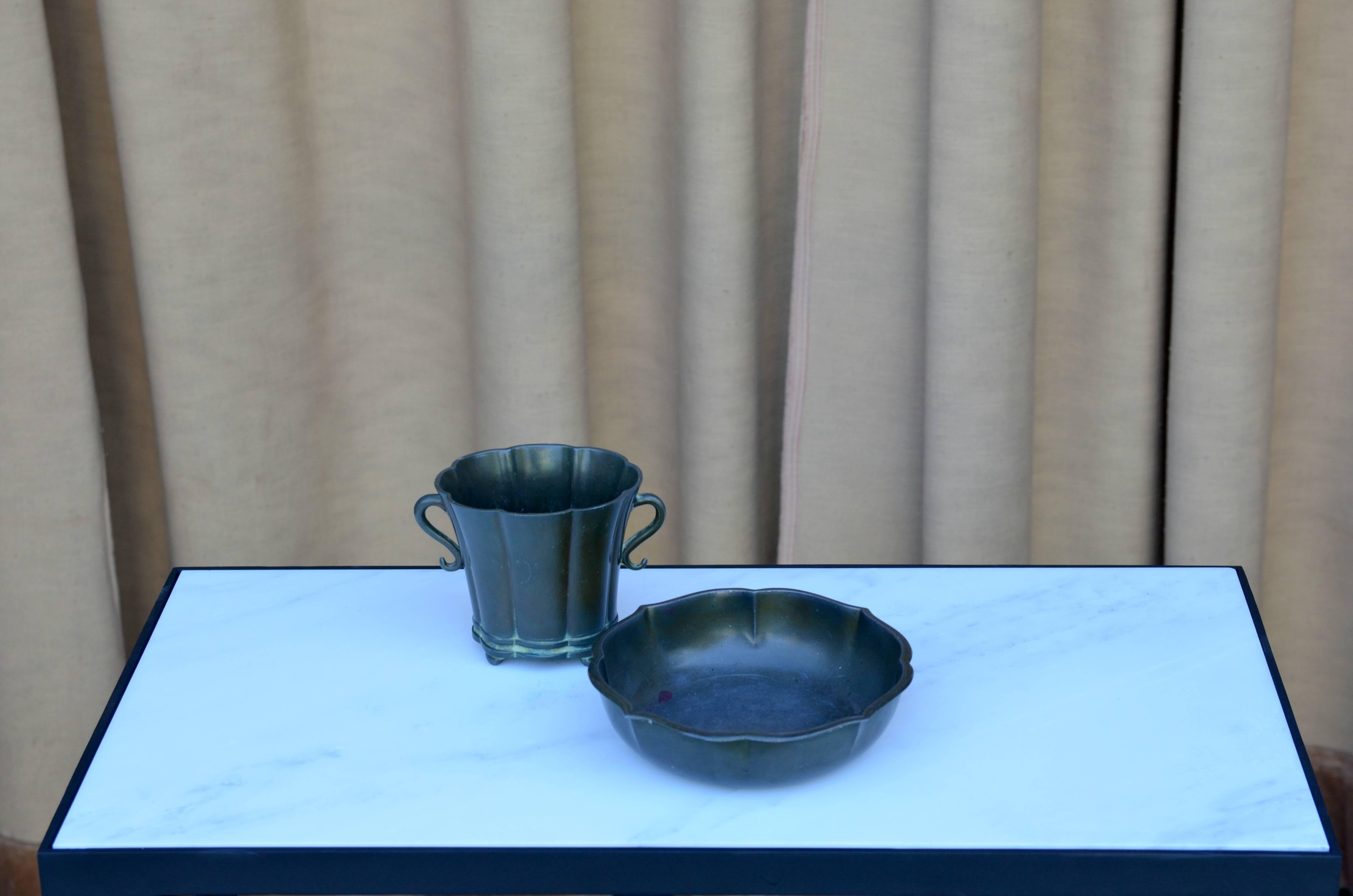 Set of Two Scalloped Disko Metal Bowls by Just Andersen. Stamped.

Vase is 7 in. dia x 2 in. tall;
Bowl is 6 in. wide x 3.5 in. deep x 4 in. tall.

IB Just Andersen was born on July 13th 1884 in Godhavn, Greenland. His first apprenticeship was