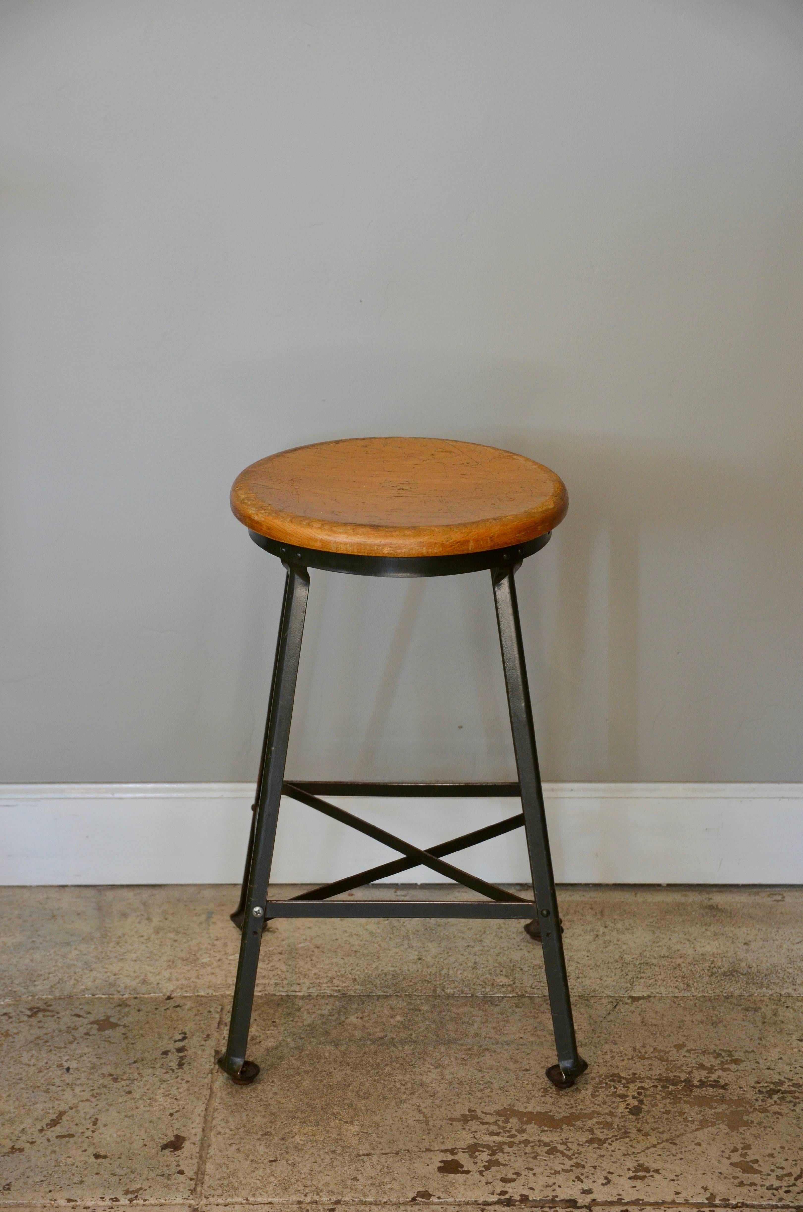 Great set of four vintage Industrial steel and turned wood counter stools. Comfortable concave shaped seats.

The wood seats are 14 in. diameter.

Only sold as a set of three.