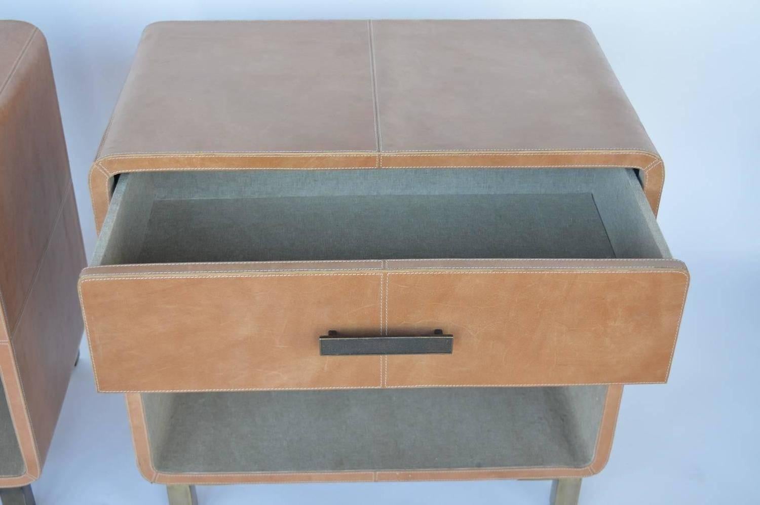 Pair of light brown leather upholstered nightstands.