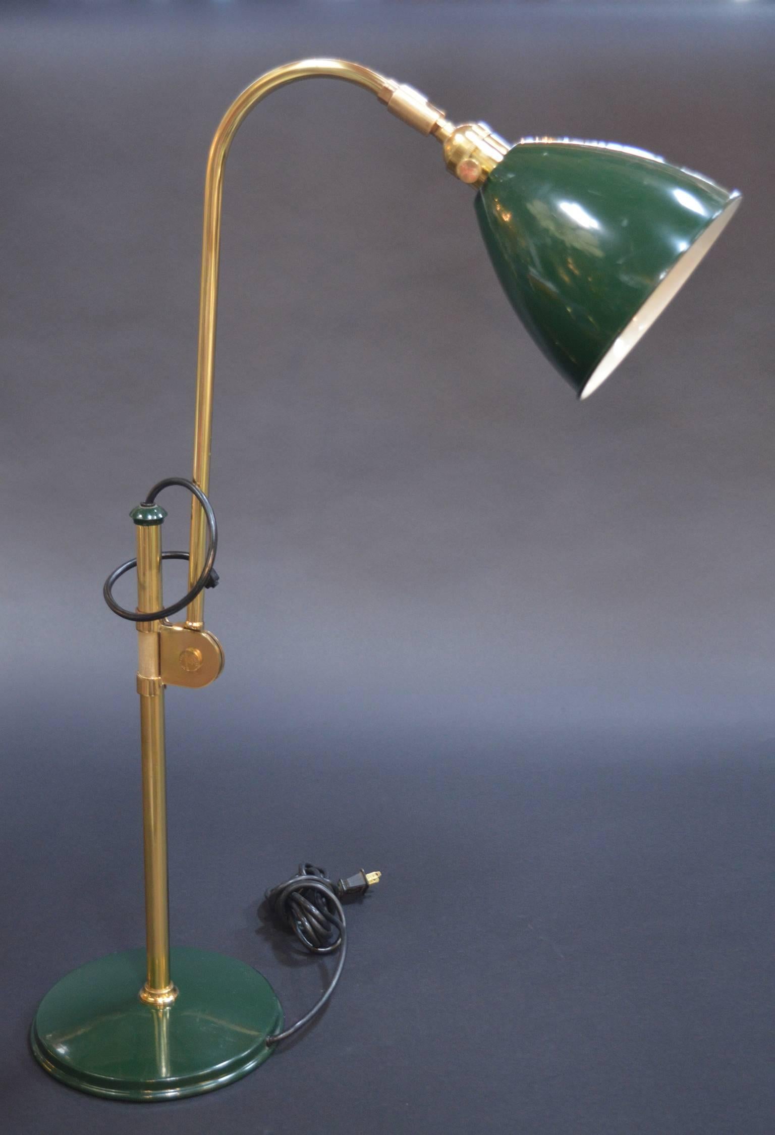 Drafting lamp by Louis Baldinger of painted sheet steel in green and brass. Fully articulated at lamp hood and center of stem.