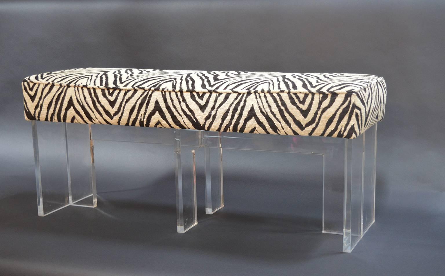 Zebra print upholstered Lucite bench.